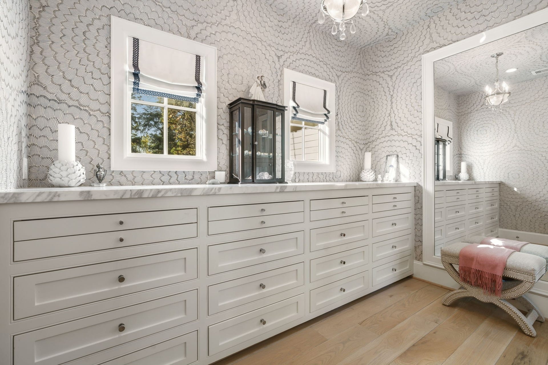14 Peony Springs Court, The Woodlands, TX 77382 A drawer for every treasure, this exceptional custom built-in system makes getting dressed feel like a private boutique experience. Enjoy a marble countertop and custom Roman shades with trim detail tied to the hand-blocked wallcovering.