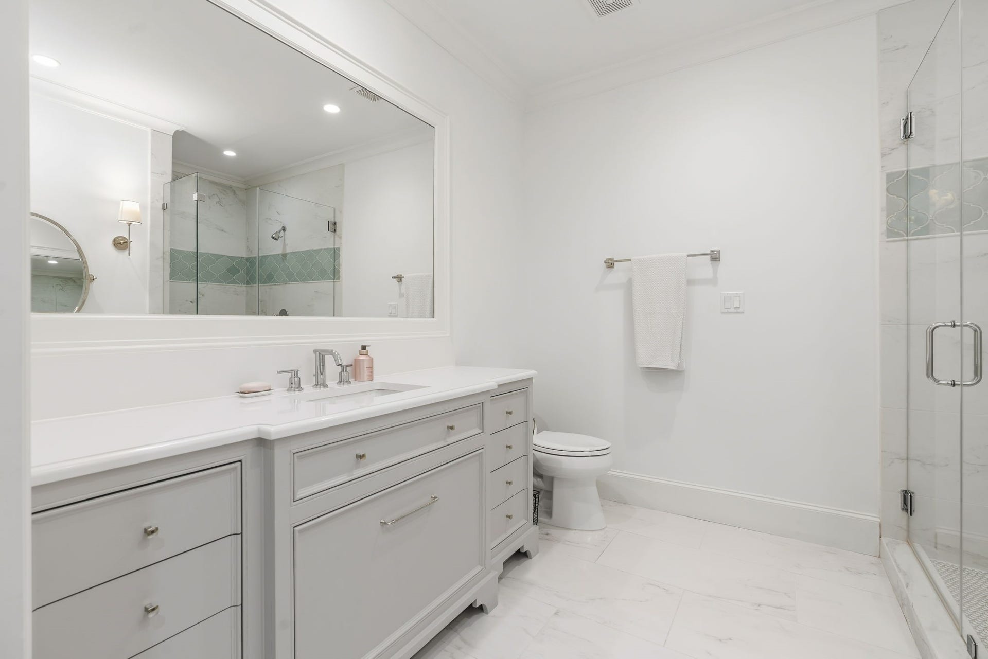14 Peony Springs Court, The Woodlands, TX 77382 Secondary bedroom 2 - adjoining bath features a French-inspired dresser-style vanity and sink with bead trim and bracket legs feels welcoming as you enjoy the oversized shower.