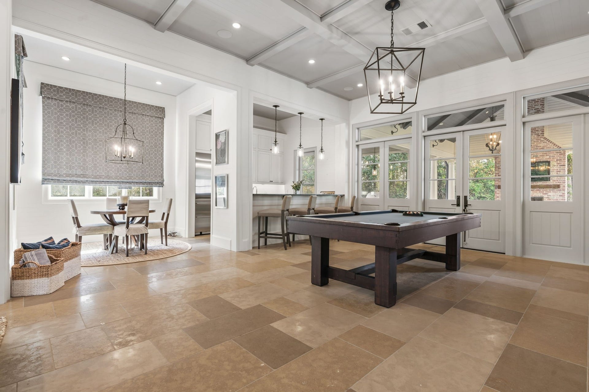14 Peony Springs Court, The Woodlands, TX 77382 Fantastic open concept first floor billiards room complete with double door access to the outdoor entertaining venues.The floor is reclaimed antique French limestone, and the kitchen countertops are solid slate.