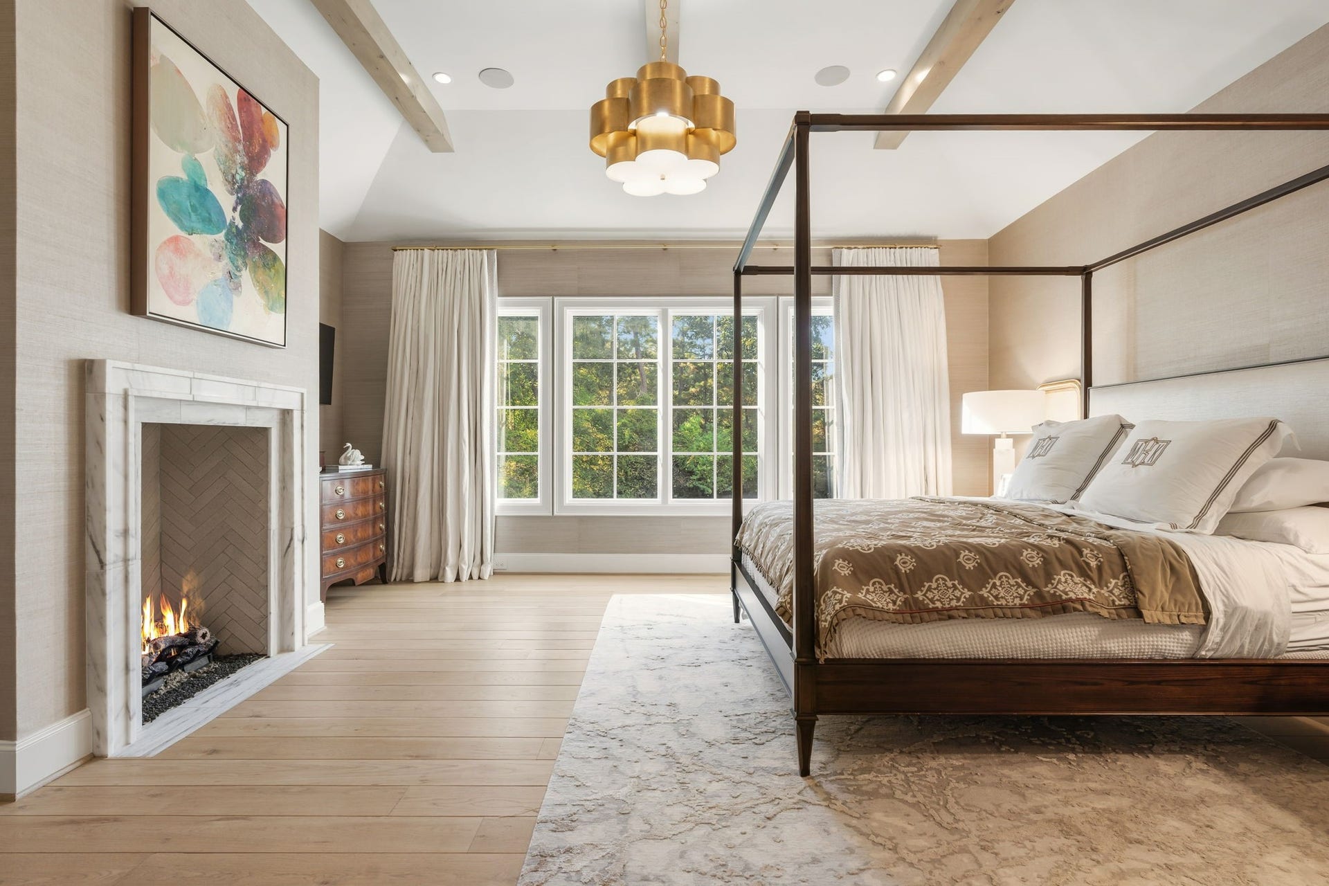 14 Peony Springs Court, The Woodlands, TX 77382 Highlighting a gorgeous gas fireplace and picturesque views of the back landscape, this primary retreat does not disappoint!