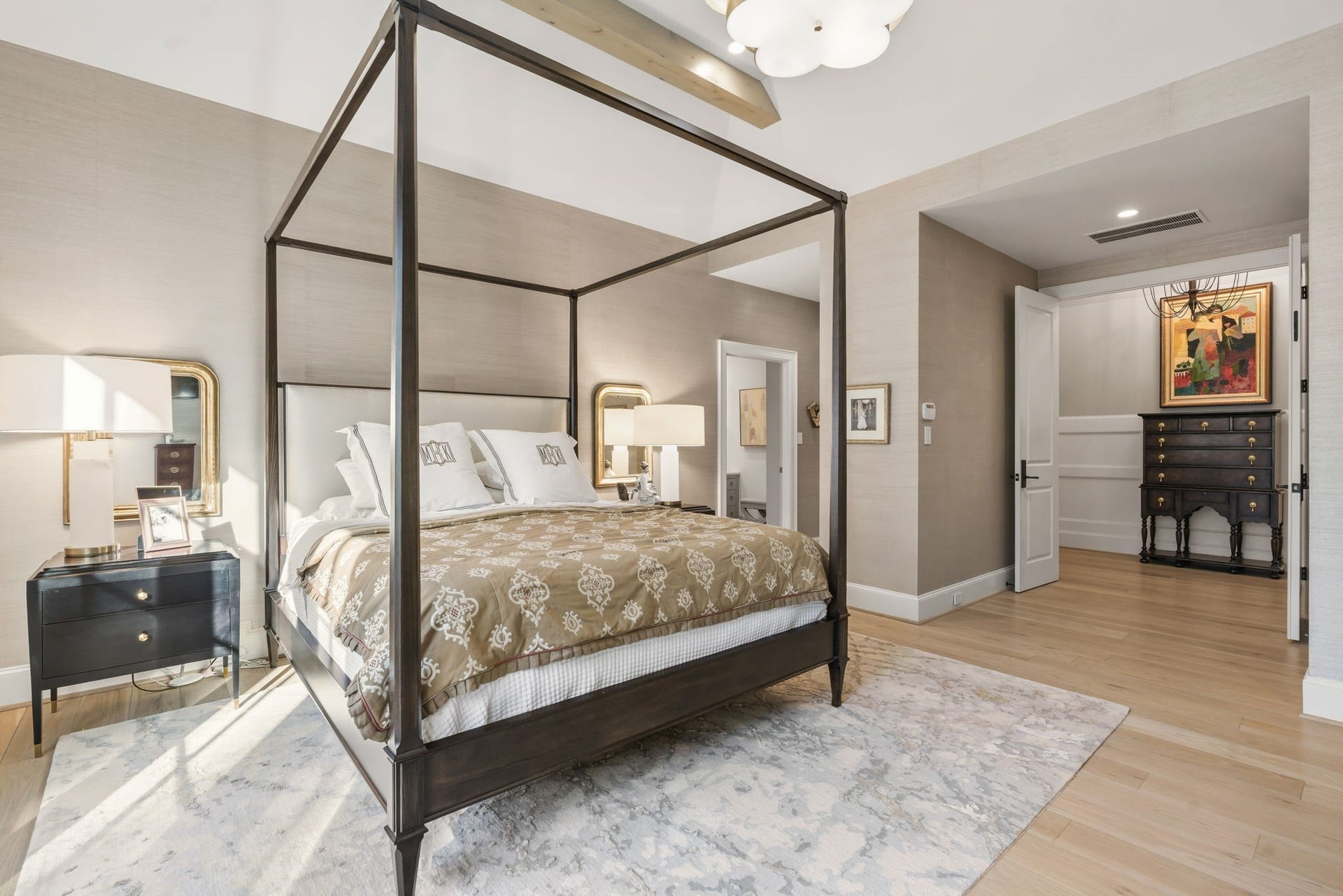 14 Peony Springs Court, The Woodlands, TX 77382 Second floor primary suite! Warm toned sisal wallcovering wraps the entire space highlighting beams, another modern marble fireplace, and bank of windows floating over the private backyard.