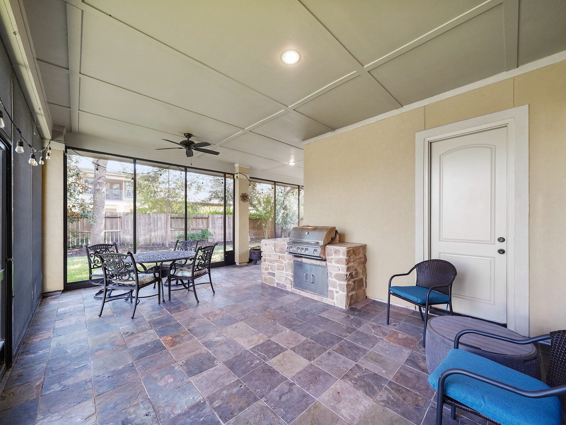 5907 Hawthorne Garden Way, Katy, TX 77494 Slate floors, a ceiling fan, and room for comfortable seating give this enclosed outdoor retreat an easy, polished feel.