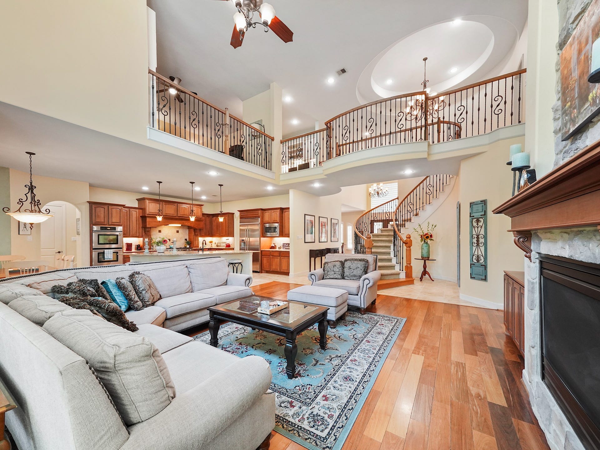 5907 Hawthorne Garden Way, Katy, TX 77494 This welcoming gathering space balances architectural presence with everyday comfort, anchored by the fireplace and expansive hardwood floors.