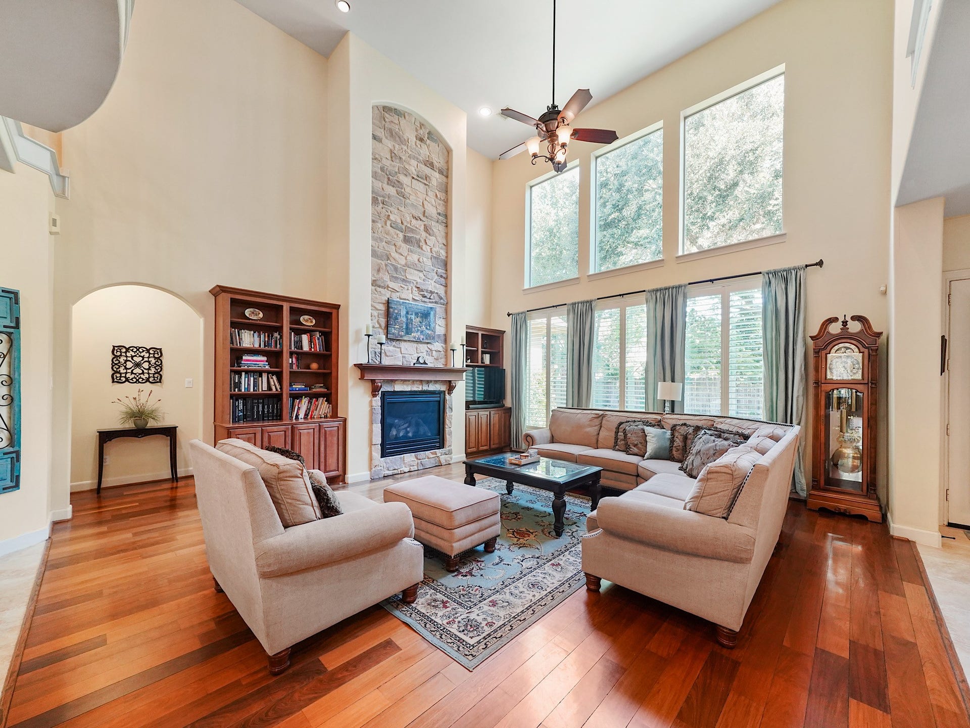 5907 Hawthorne Garden Way, Katy, TX 77494 A wall of tall windows and an upper-level overlook give the family room a bright, dramatic sense of scale.