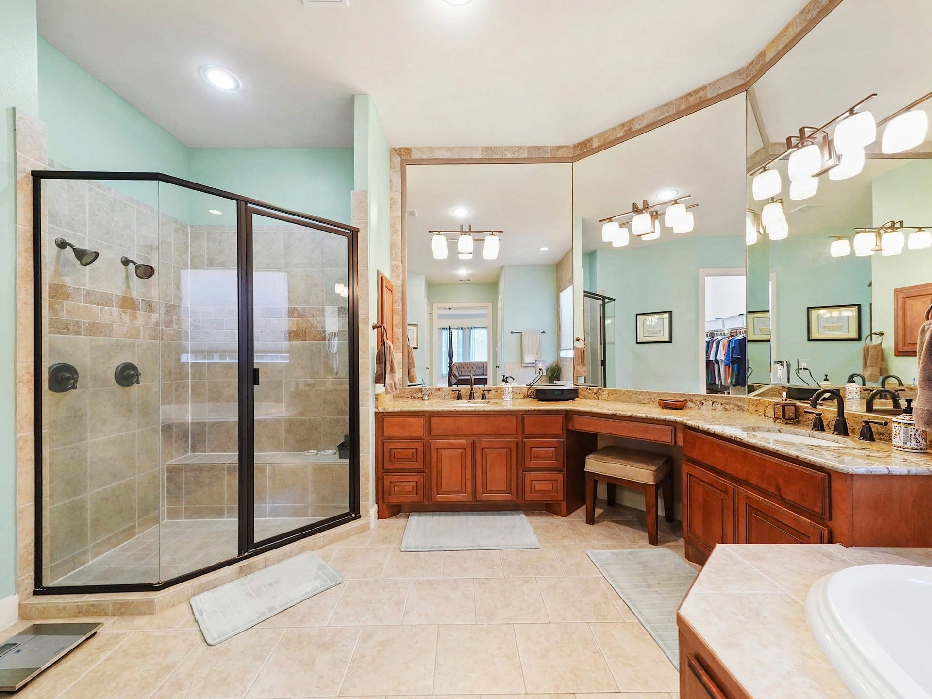 5907 Hawthorne Garden Way, Katy, TX 77494 Separate vanities, a glass-enclosed shower, and refined finishes complete the primary baths everyday luxury.