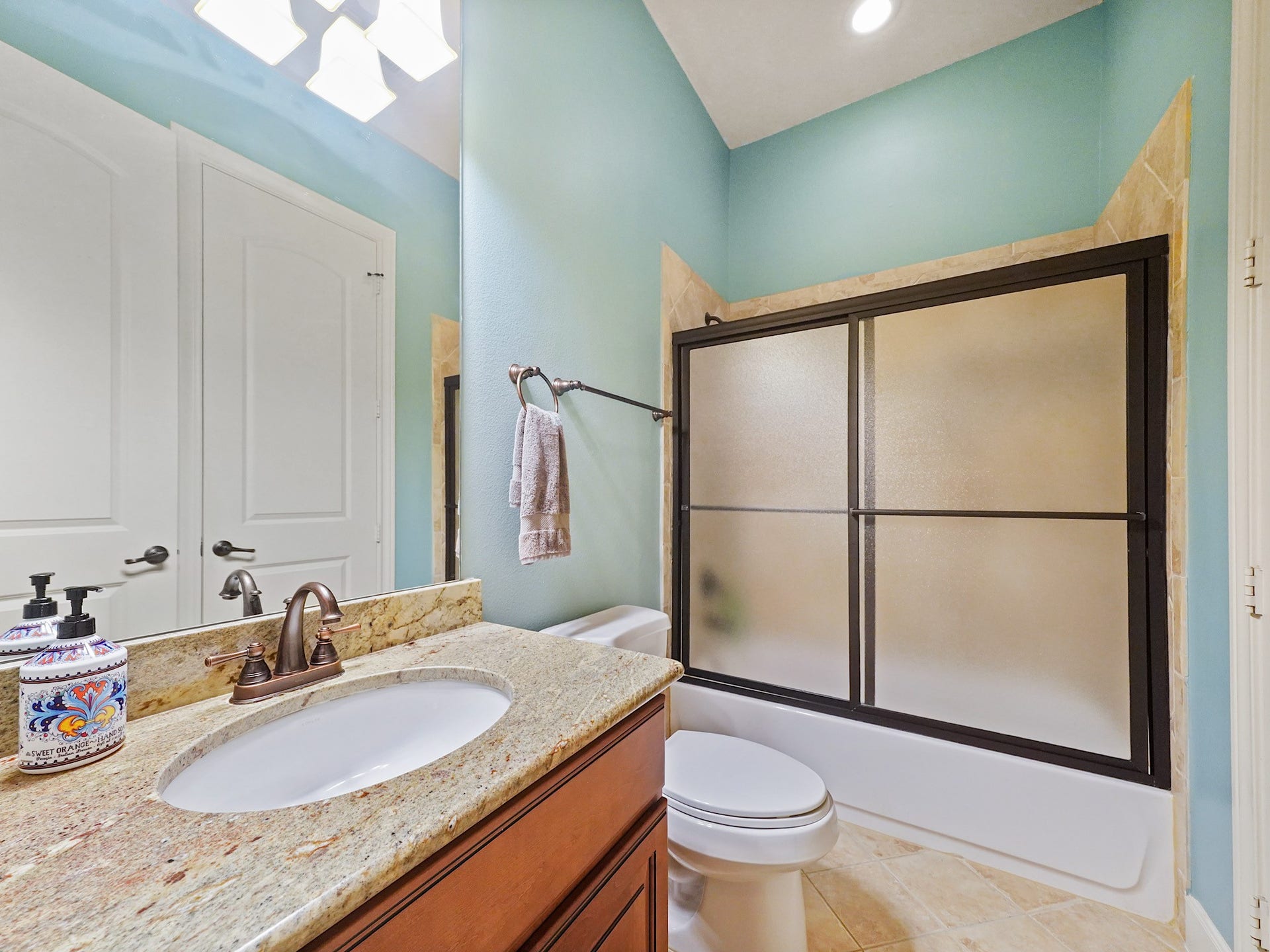 5907 Hawthorne Garden Way, Katy, TX 77494 The accompanying full bath offers granite finishes and a shower enclosure for a polished guest experience.