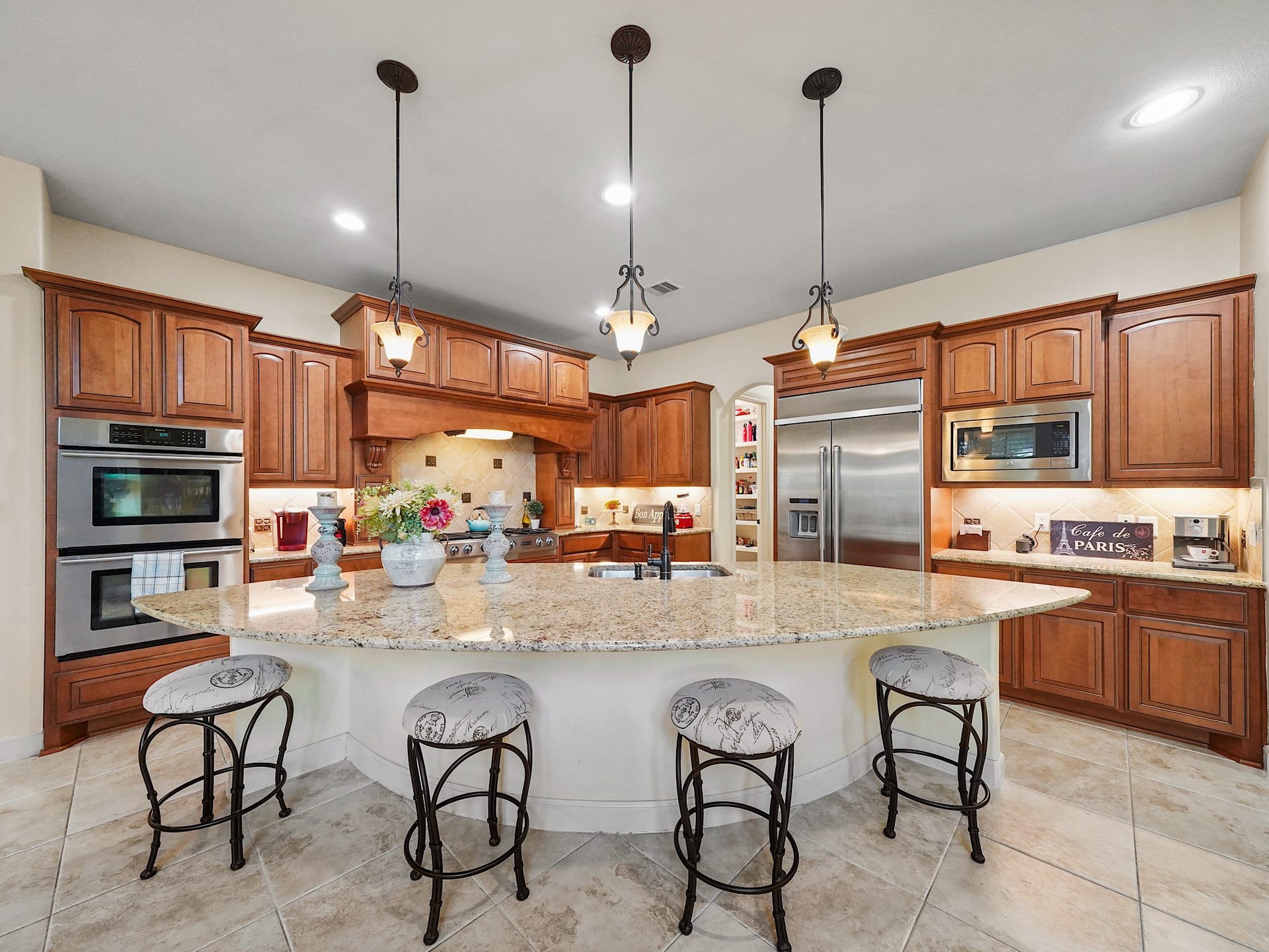 5907 Hawthorne Garden Way, Katy, TX 77494 The large granite-topped island offers generous room for prep, serving, and gathering with guests.
