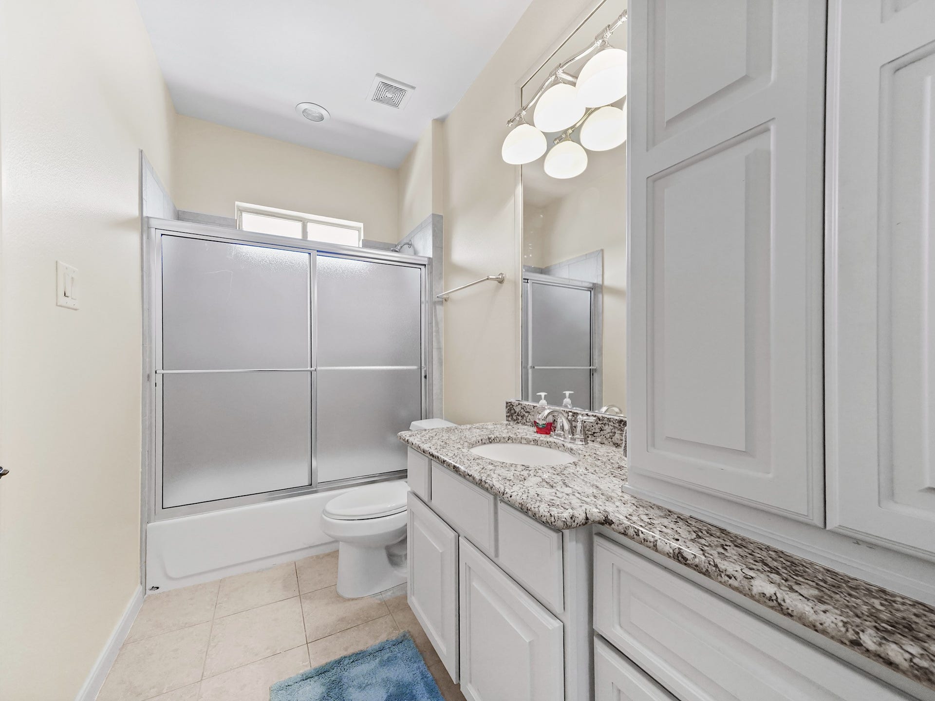 5907 Hawthorne Garden Way, Katy, TX 77494 This upstairs en-suite bath features a double vanity, granite countertop, and glass-enclosed shower.