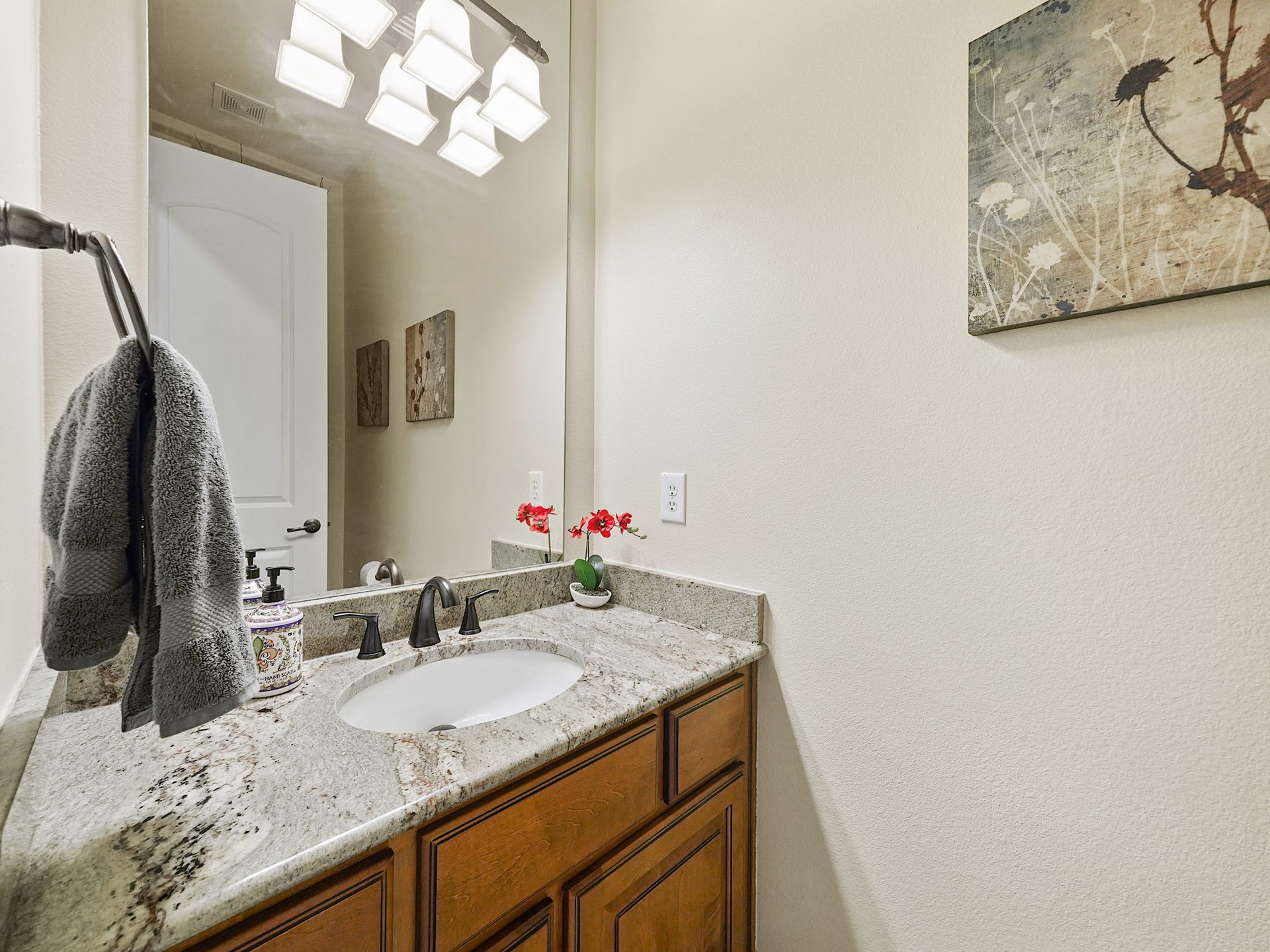 5907 Hawthorne Garden Way, Katy, TX 77494 A polished powder bath continues the homes tailored feel with granite countertops, warm cabinetry, and thoughtful finishes.