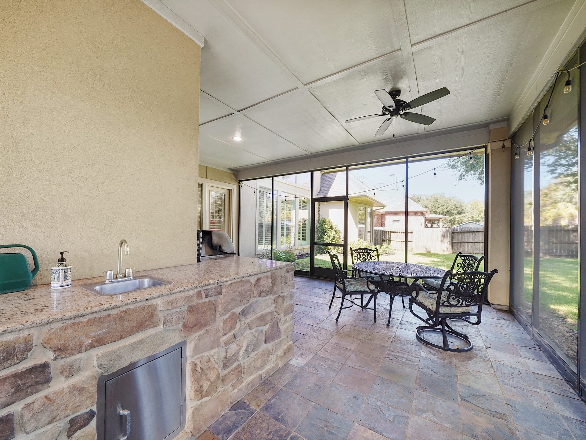 5907 Hawthorne Garden Way, Katy, TX 77494 Screened walls invite in backyard views and fresh air while creating a comfortable place to linger well beyond sunset.