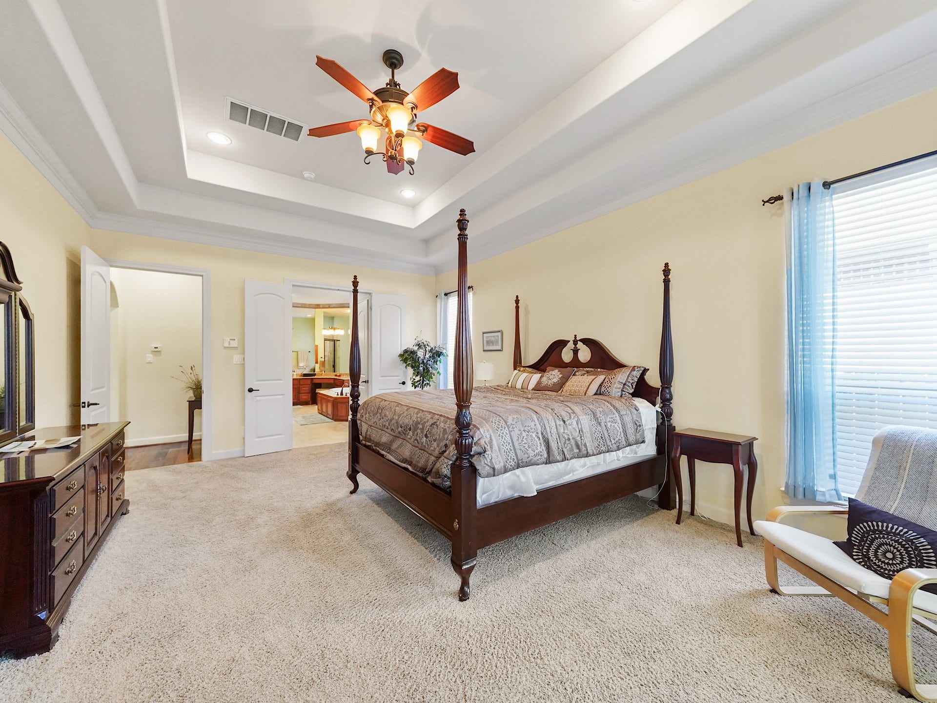 5907 Hawthorne Garden Way, Katy, TX 77494 Soft natural light and detailed ceiling treatment give the primary suite a calm, private feel at the end of the day.