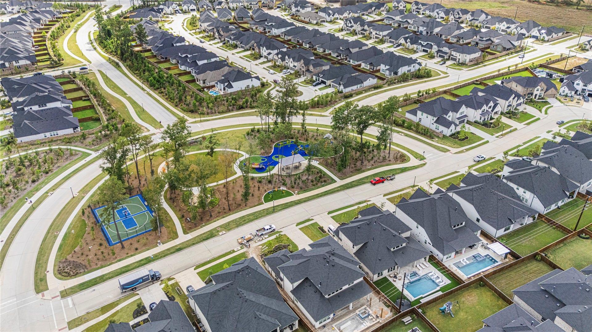 4810 Antler Run Drive, Spring, TX 77386 Charming suburban neighborhood featuring modern homes with spacious backyards, a vibrant community park, and sports courts, offering an ideal setting for family living and outdoor activities.