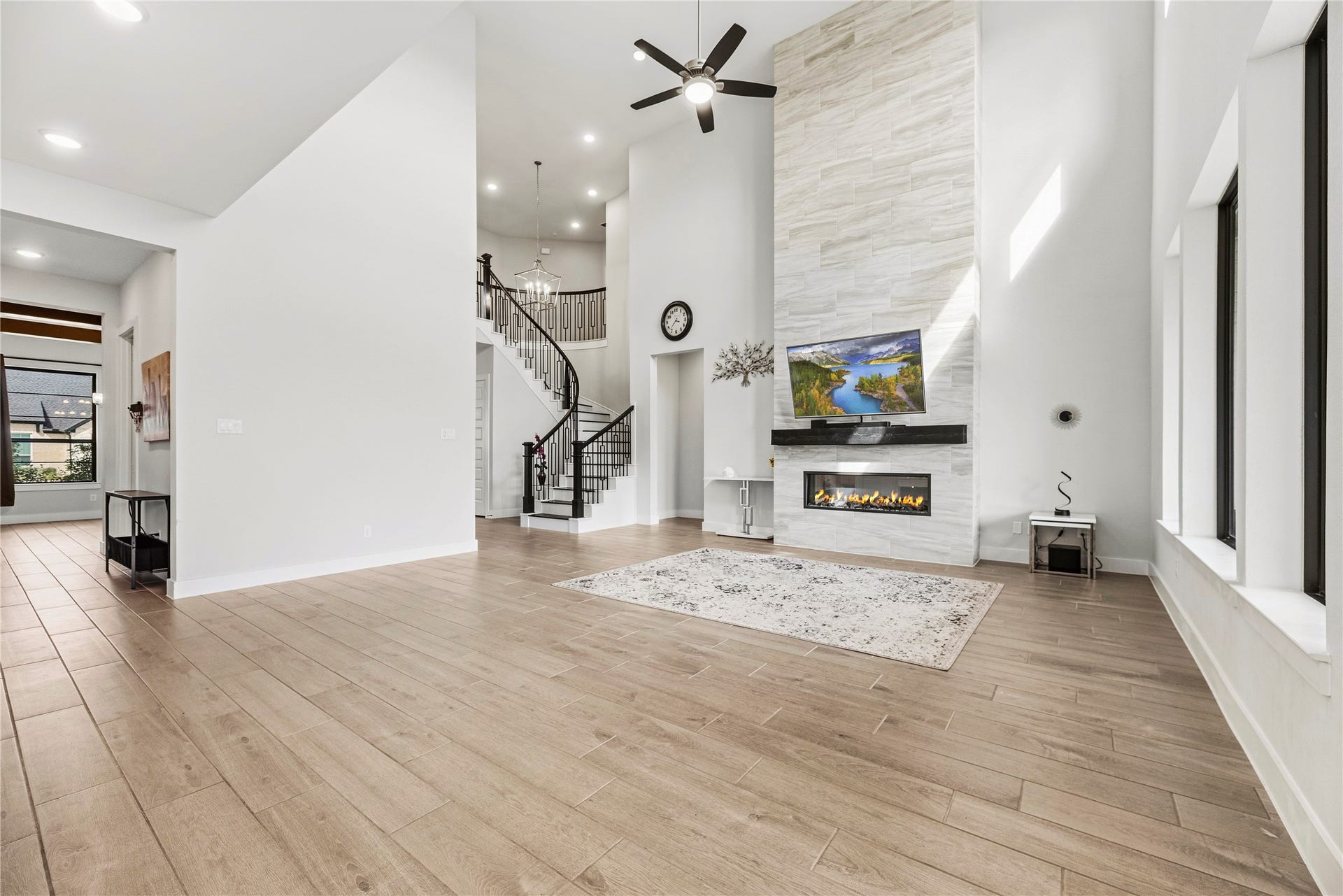 4810 Antler Run Drive, Spring, TX 77386 Spacious living area with soaring ceilings, modern fireplace, and elegant staircase, perfect for comfortable and stylish living.
