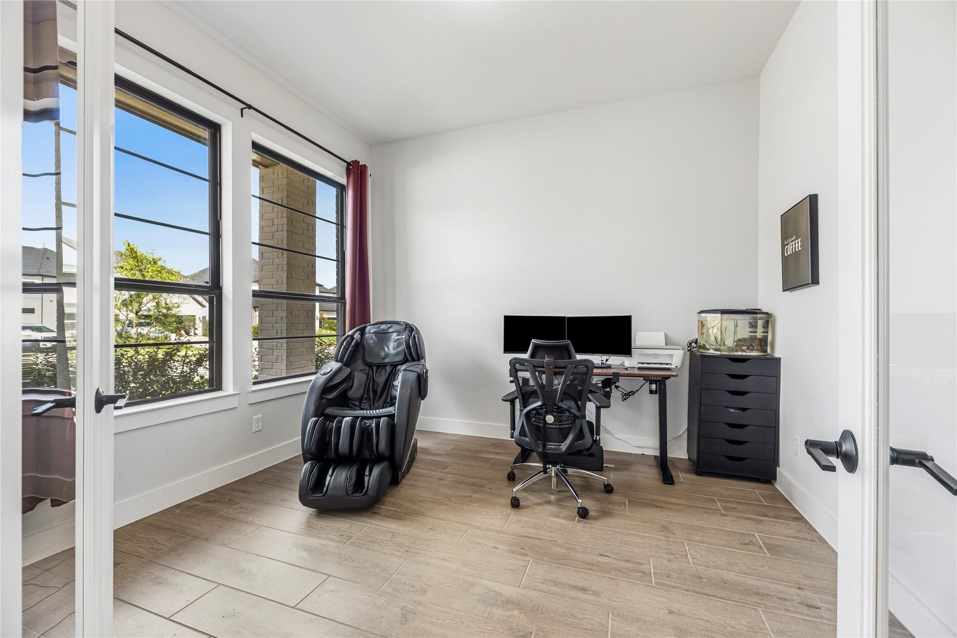 4810 Antler Run Drive, Spring, TX 77386 Bright and inviting home office featuring large windows, sleek flooring, and ample space for productivity. The bronze window frames are a pricey upgrade.