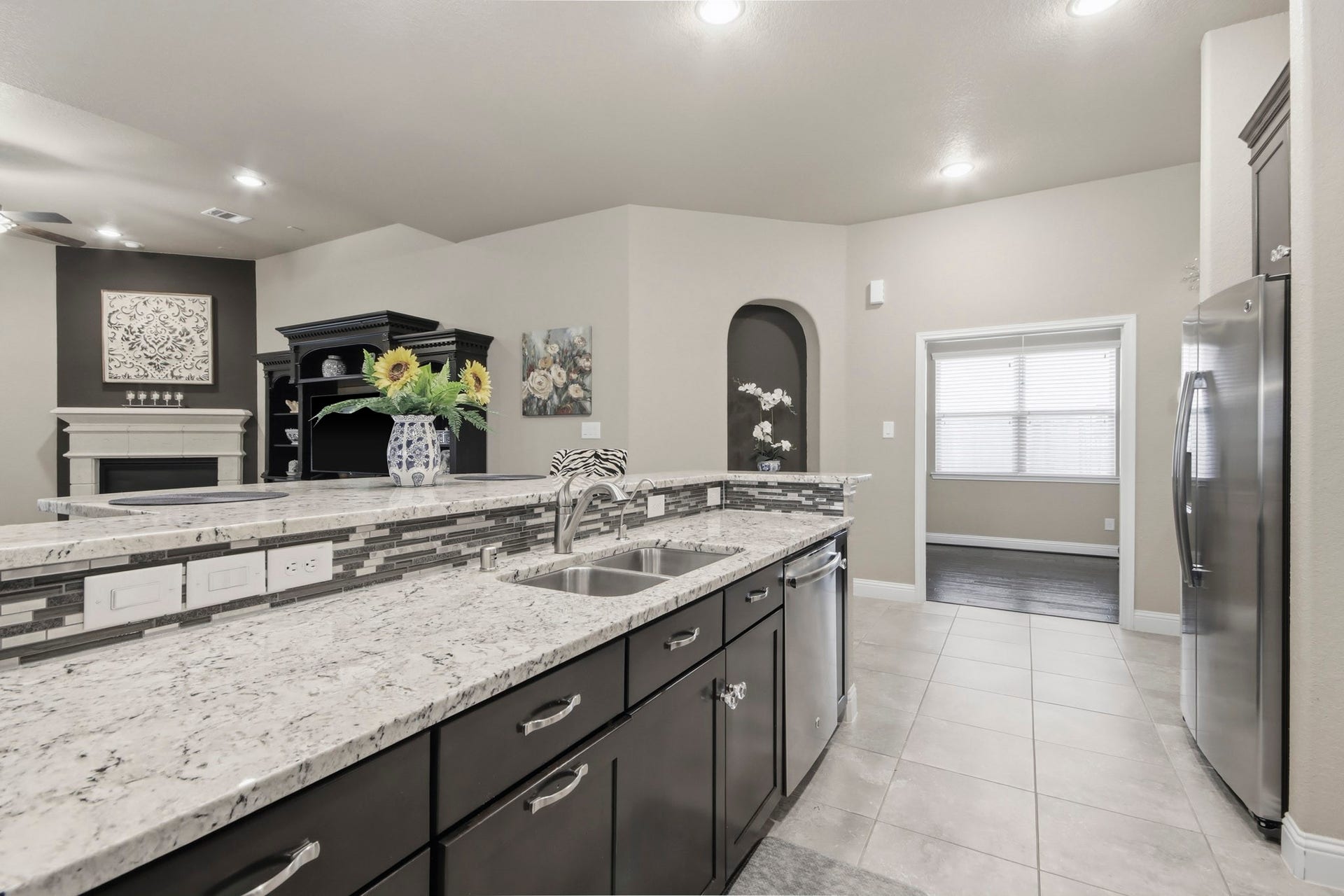 11 Whispering Thicket Place, The Woodlands, TX 77375 Spacious open layout that flows into the living area featuring a cozy fireplace.