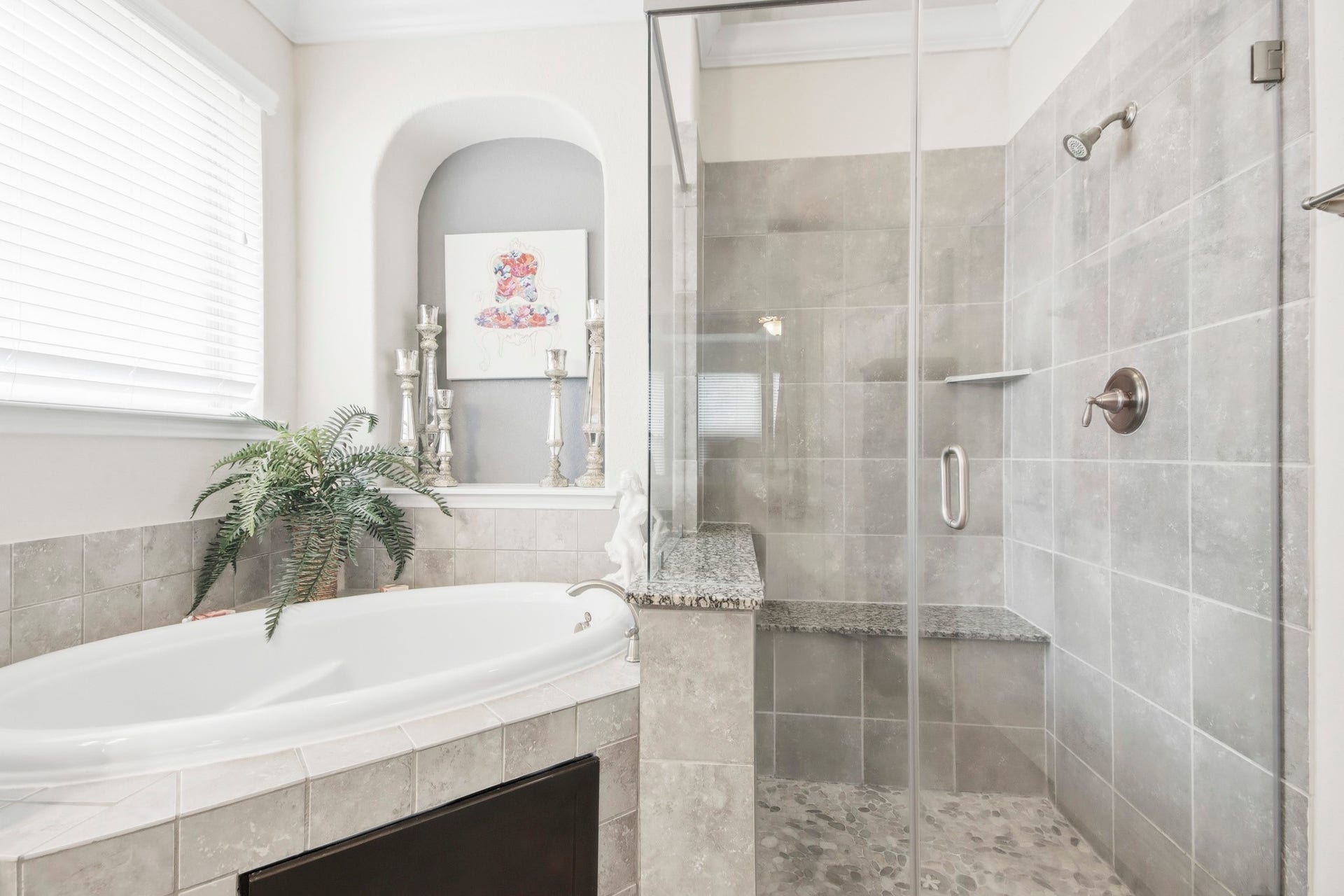 11 Whispering Thicket Place, The Woodlands, TX 77375 Primary bathroom featuring a spacious glass-enclosed shower with sleek tile work and a relaxing soaking tub.