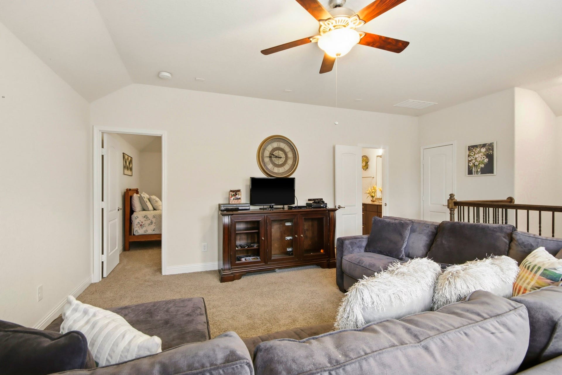 11 Whispering Thicket Place, The Woodlands, TX 77375 Game room area featuring a ceiling fan for added comfort and convenient access to an adjacent bedroom.