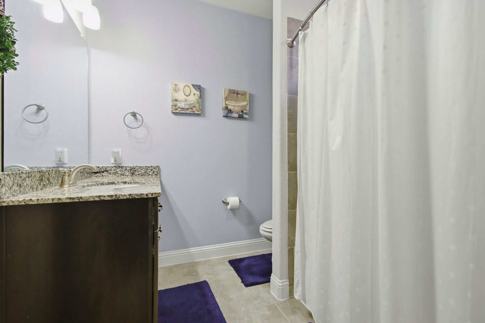 11 Whispering Thicket Place, The Woodlands, TX 77375 Updated bathroom featuring a granite countertop with a sleek vanity, complemented by a tiled shower and a large walk-in closet.