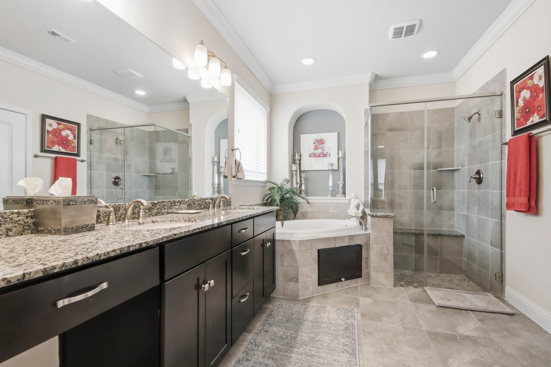 11 Whispering Thicket Place, The Woodlands, TX 77375 Luxurious bathroom featuring a spacious dual-sink vanity with granite countertops, a relaxing soaking tub, and a sleek glass-enclosed shower.