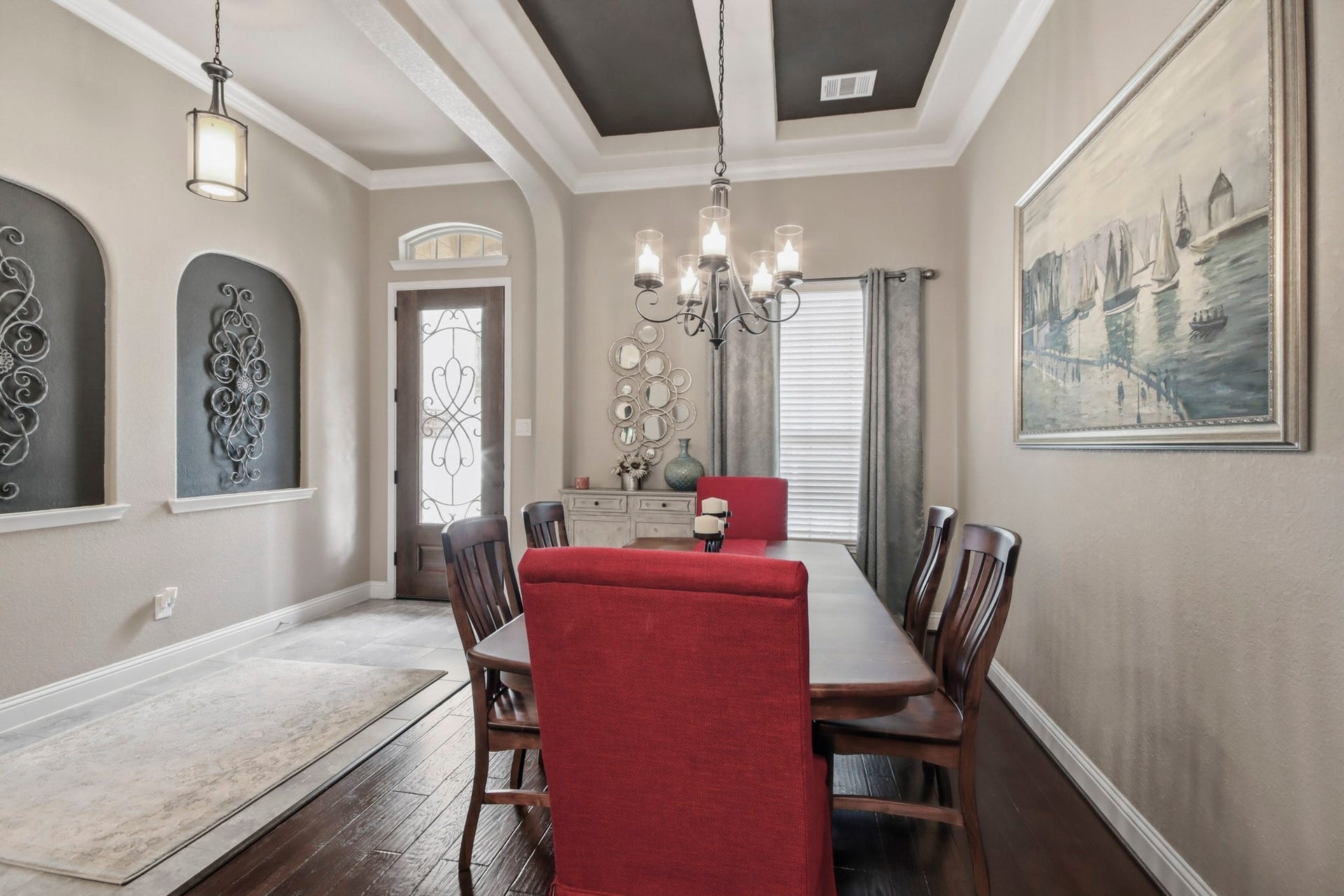 11 Whispering Thicket Place, The Woodlands, TX 77375 Dining room featuring a coffered ceiling and striking chandelier complemented by a large window for natural light.