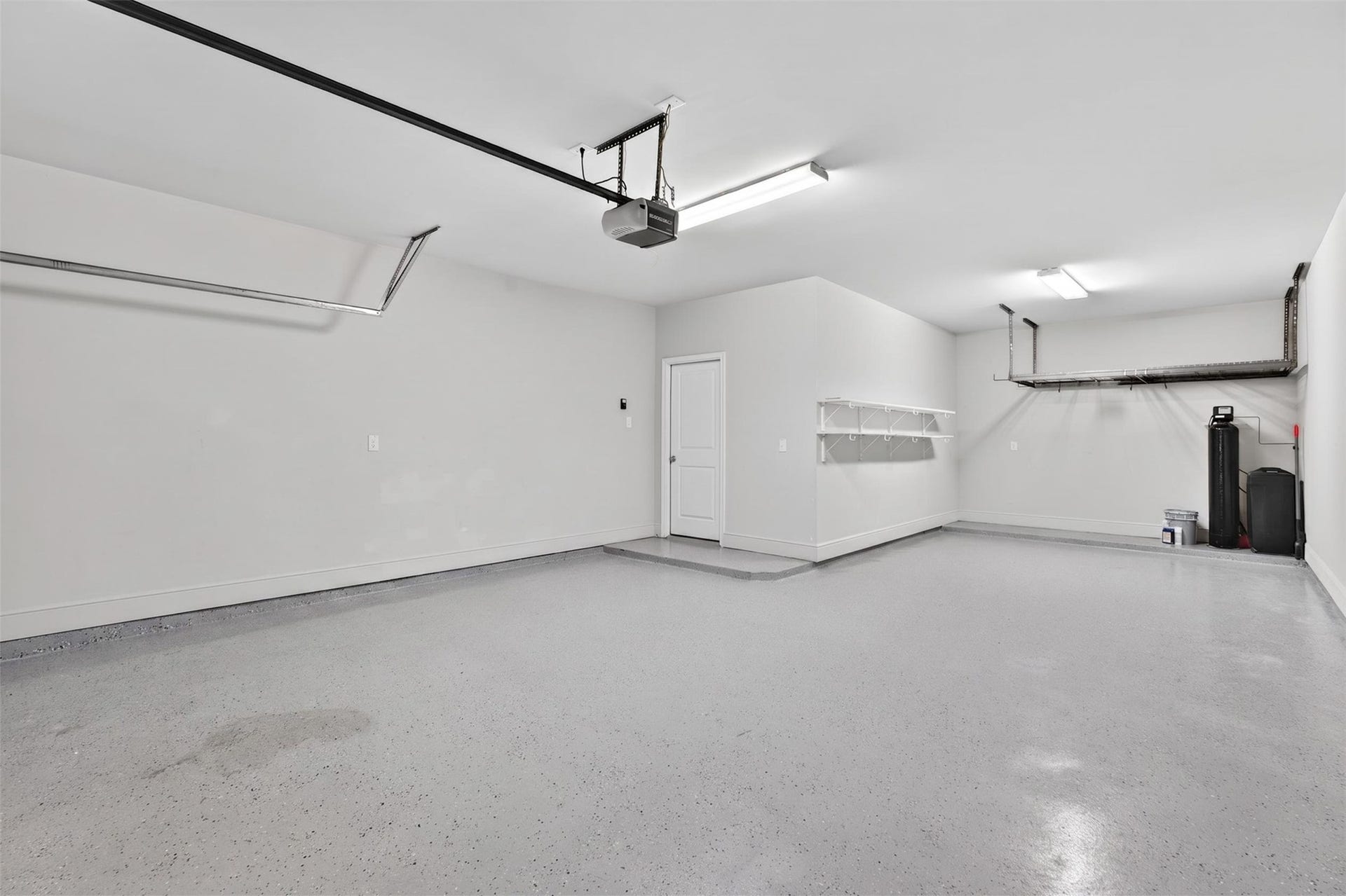 3123 Lantana Trail, Katy, TX 77493 The spacious three-car garage offers ample room for vehicles, storage, tools, and recreational equipment. Finished with durable epoxy flooring, the space features a clean, polished appearance while providing long-lasting performance and easy maintenance.