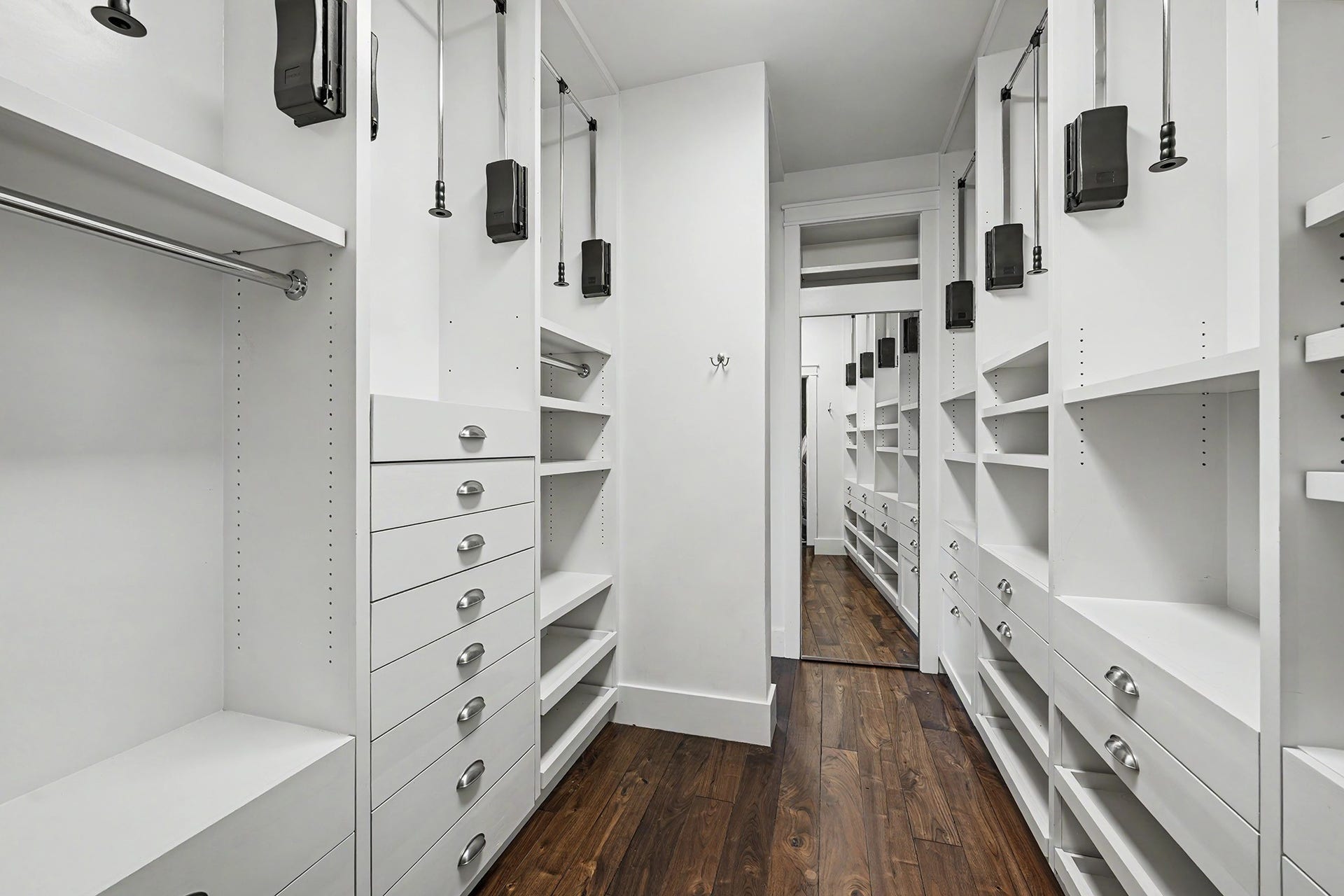 4153 Oberlin Street, West University Place, TX 77005 The primary closet includes a full-length mirror and ample storage with drawers, shelving, and pull-down rods for clothing, shoes, and accessories.