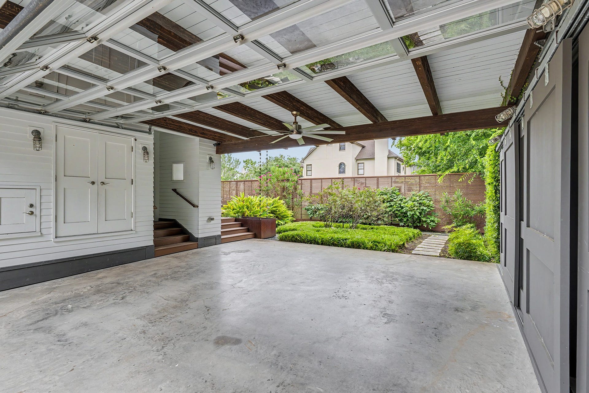4153 Oberlin Street, West University Place, TX 77005 The open garage space is equipped with ceiling fans for comfort, with stairs that provide convenient access directly into the home.