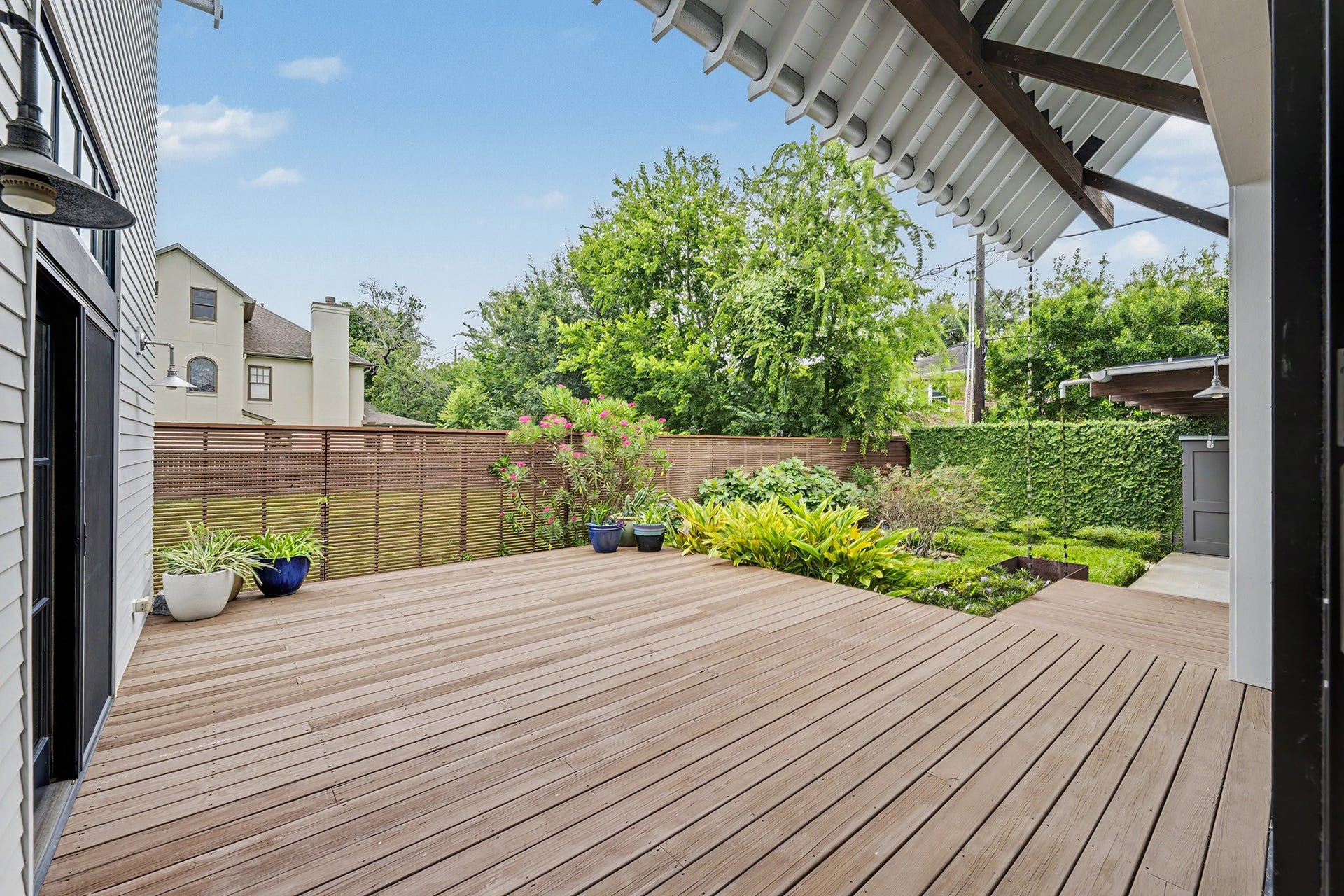 4153 Oberlin Street, West University Place, TX 77005 An expansive stained and treated pine deck extends the living space outdoors. The backyard is beautifully landscaped, offering a private and tranquil outdoor retreat.