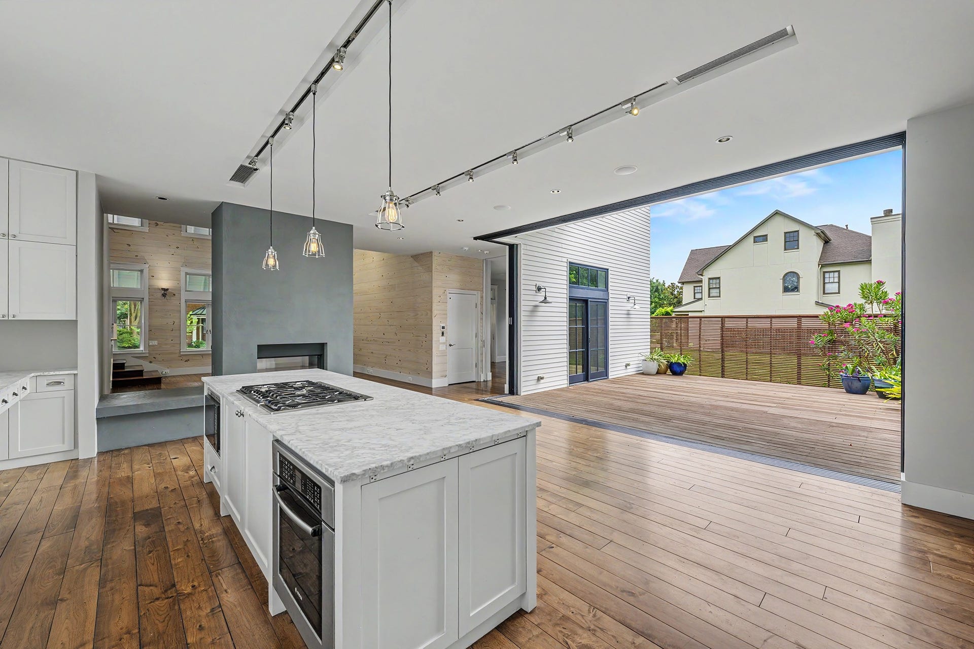 4153 Oberlin Street, West University Place, TX 77005 The fully retractable doors transform the kitchen and dining room into an expansive indoor-outdoor entertaining space, connecting the home's interior with the deck beyond.