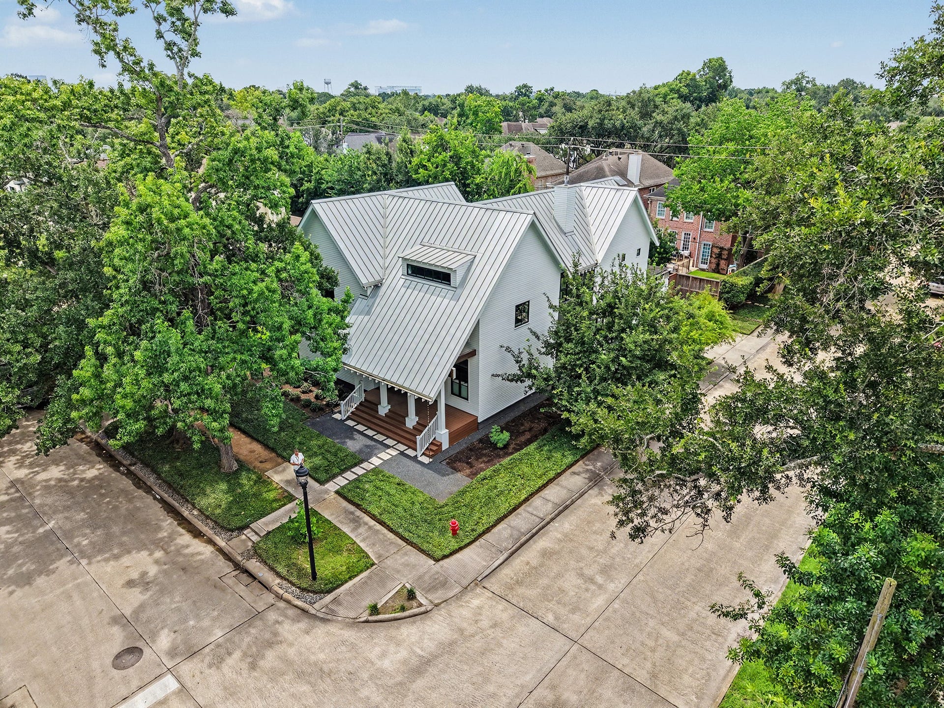 4153 Oberlin Street, West University Place, TX 77005 An aerial view showcases this incredible property situated on a corner lot in West U, surrounded by mature trees in a highly sought-after neighborhood.