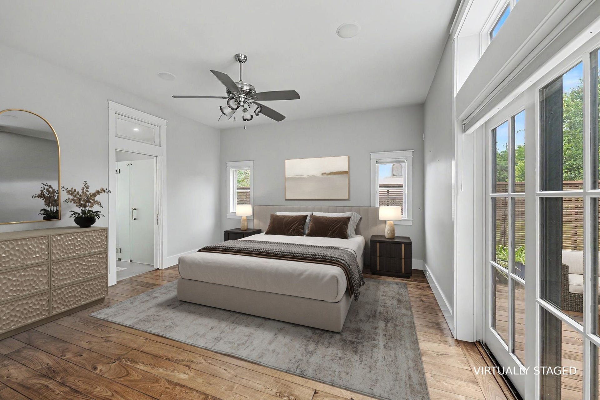 4153 Oberlin Street, West University Place, TX 77005 The spacious, light-filled primary suite offers a serene retreat with neutral finishes, beautiful flooring, and double doors opening directly to the deck. Virtually staged.