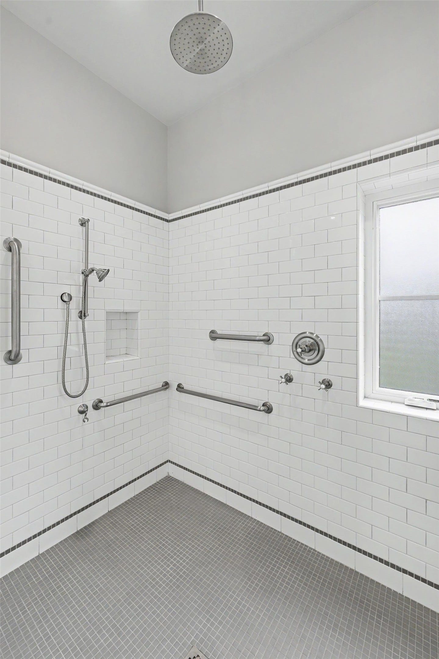 4153 Oberlin Street, West University Place, TX 77005 Generously sized primary shower with classic white subway tile and a privacy window that lets in natural light.