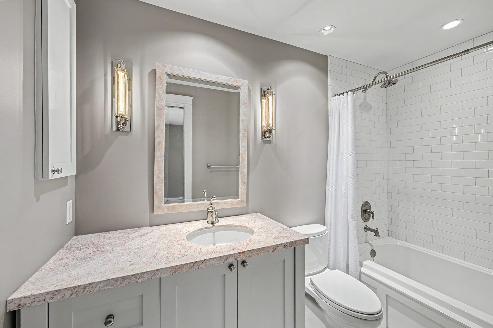 4153 Oberlin Street, West University Place, TX 77005 The ensuite bathroom with classic finishes includes a tub/shower combo and a vanity with plenty of counter and storage space.