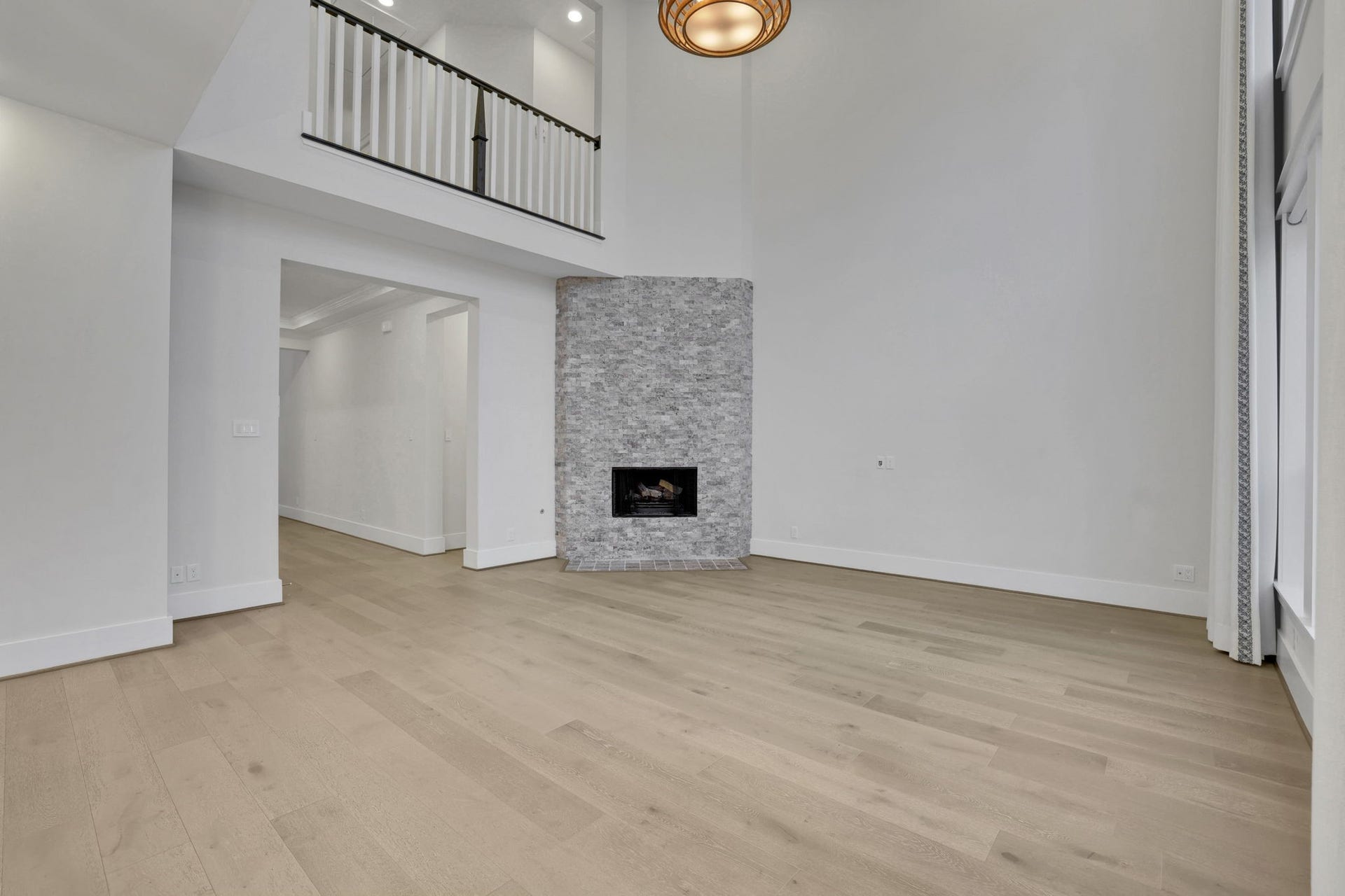 8558 Ridgepoint Drive, Houston, TX 77055 An unfurnished view shows the room's height and natural light.