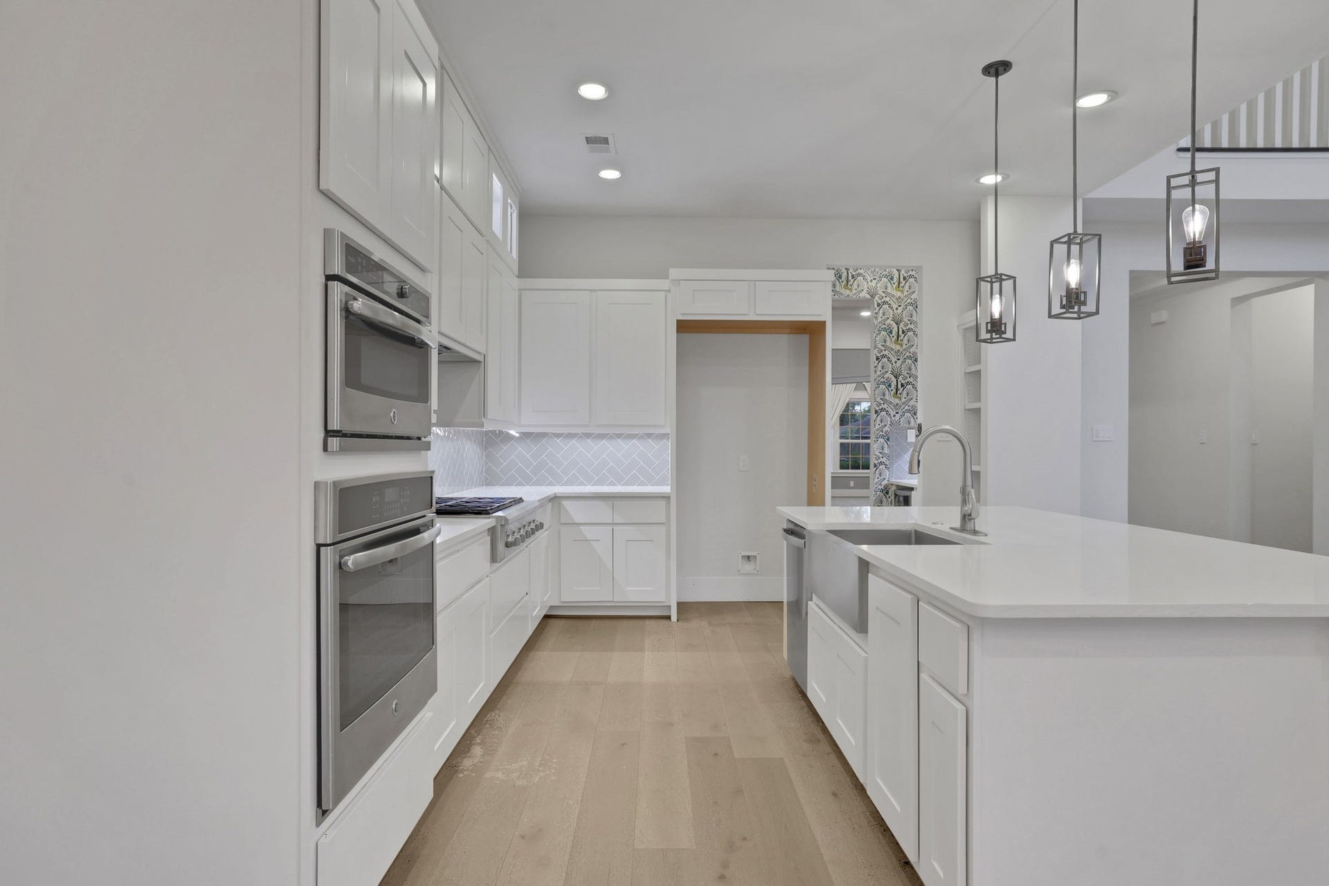 8558 Ridgepoint Drive, Houston, TX 77055 Built in ovens and white cabinetry keep the kitchen clean and functional.