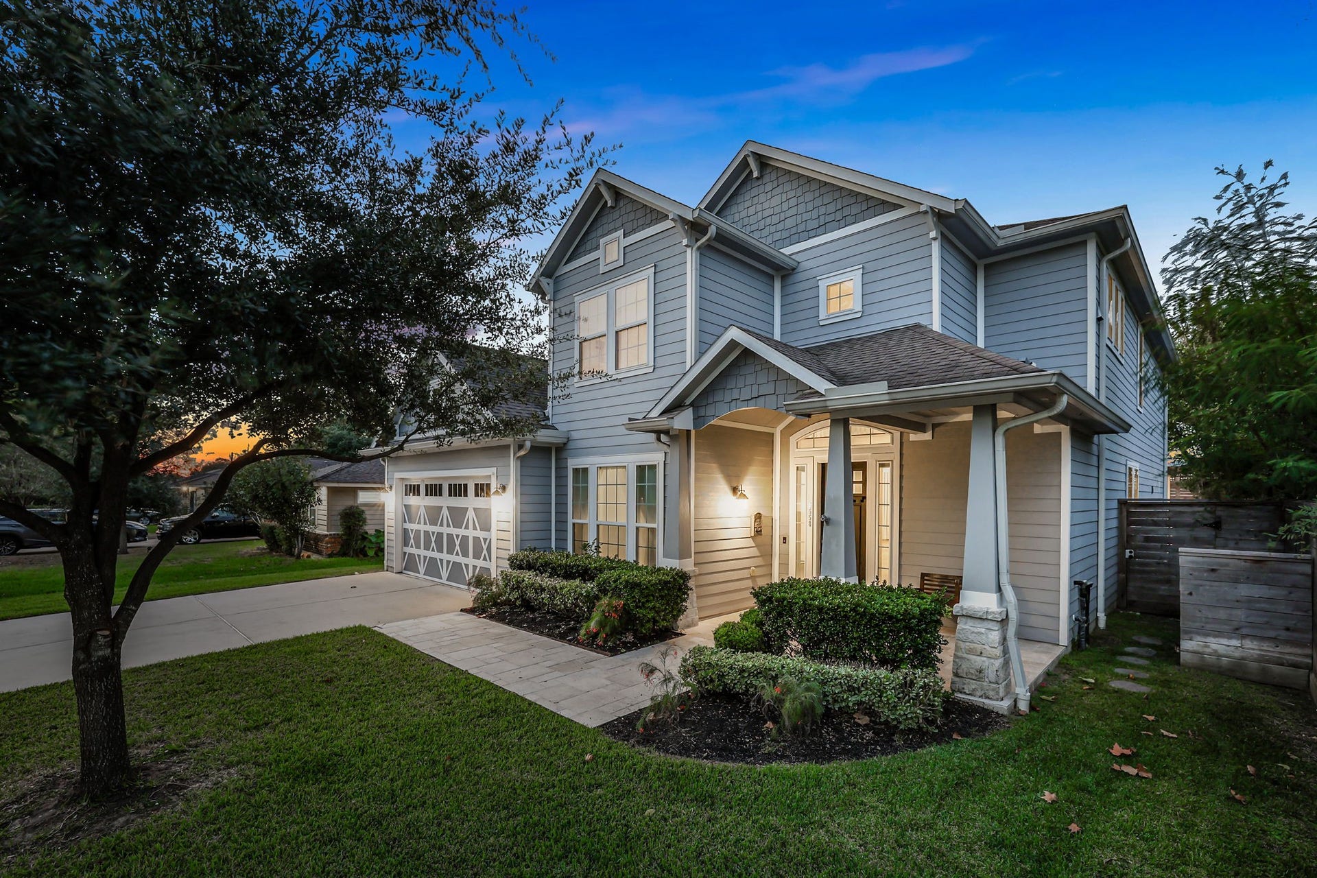 8558 Ridgepoint Drive, Houston, TX 77055 Evening light across the front elevation and mature trees.