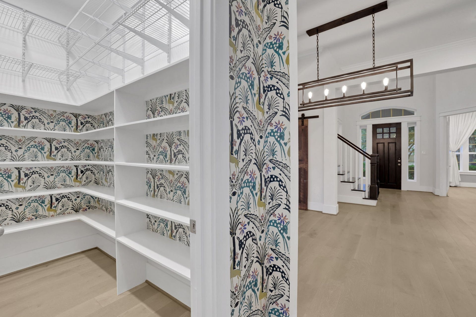 8558 Ridgepoint Drive, Houston, TX 77055 Built in shelving and a sliding door create a dedicated pantry.