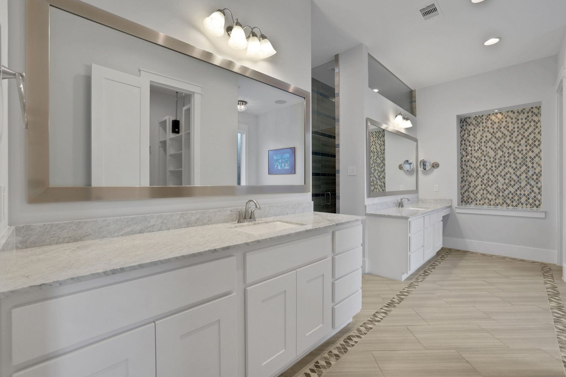 8558 Ridgepoint Drive, Houston, TX 77055 A long vanity and expansive mirror anchor the bath.