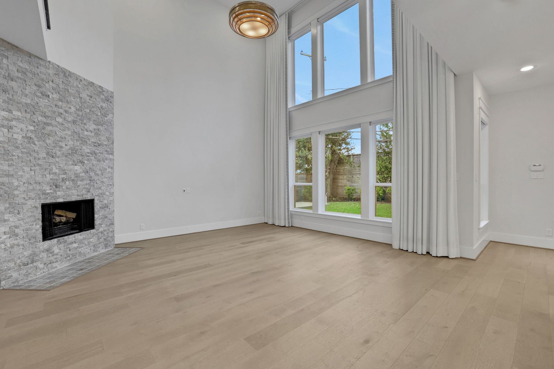 8558 Ridgepoint Drive, Houston, TX 77055 A floor to ceiling fireplace anchors the living room.