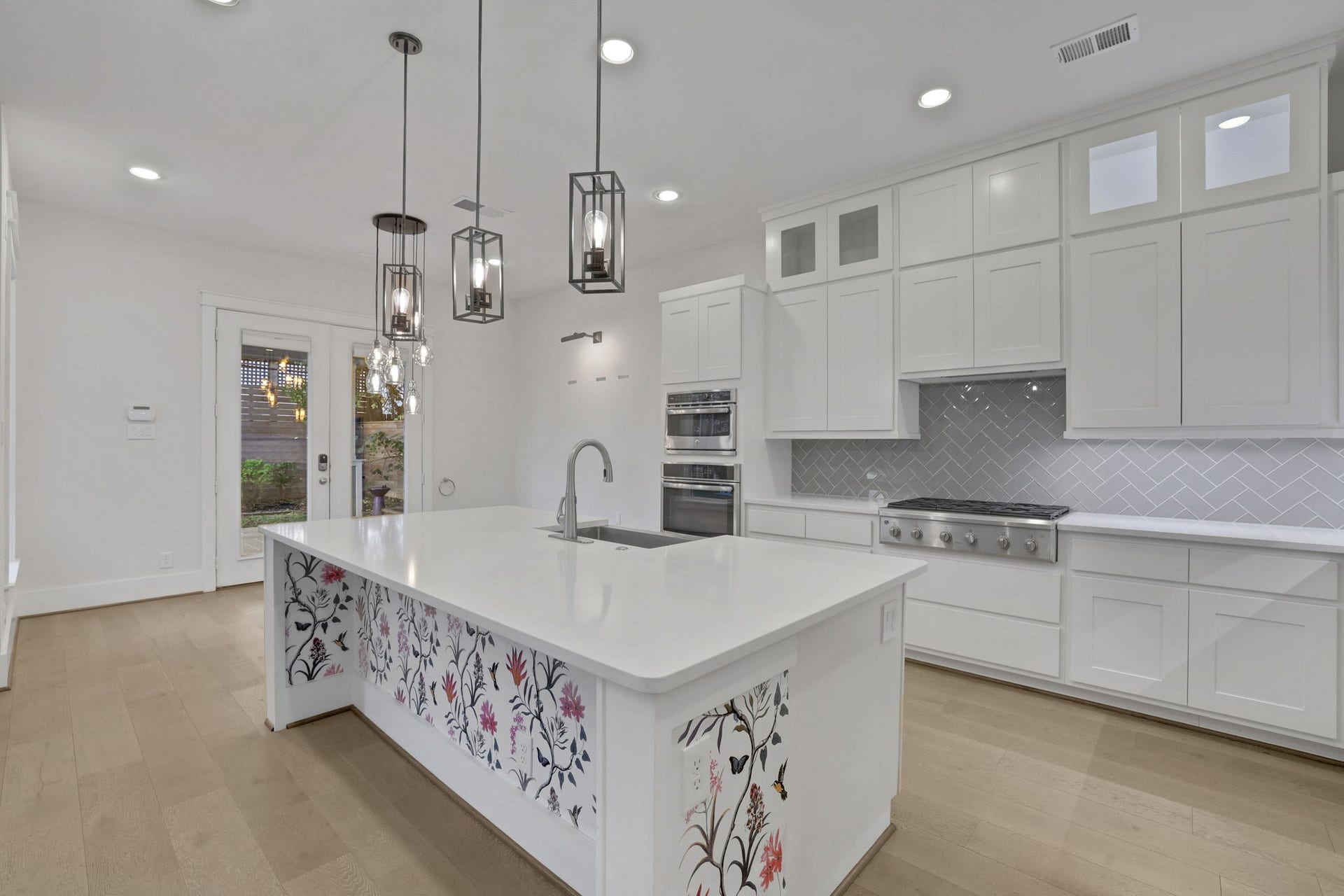8558 Ridgepoint Drive, Houston, TX 77055 A generous island and pendant lighting center the kitchen.