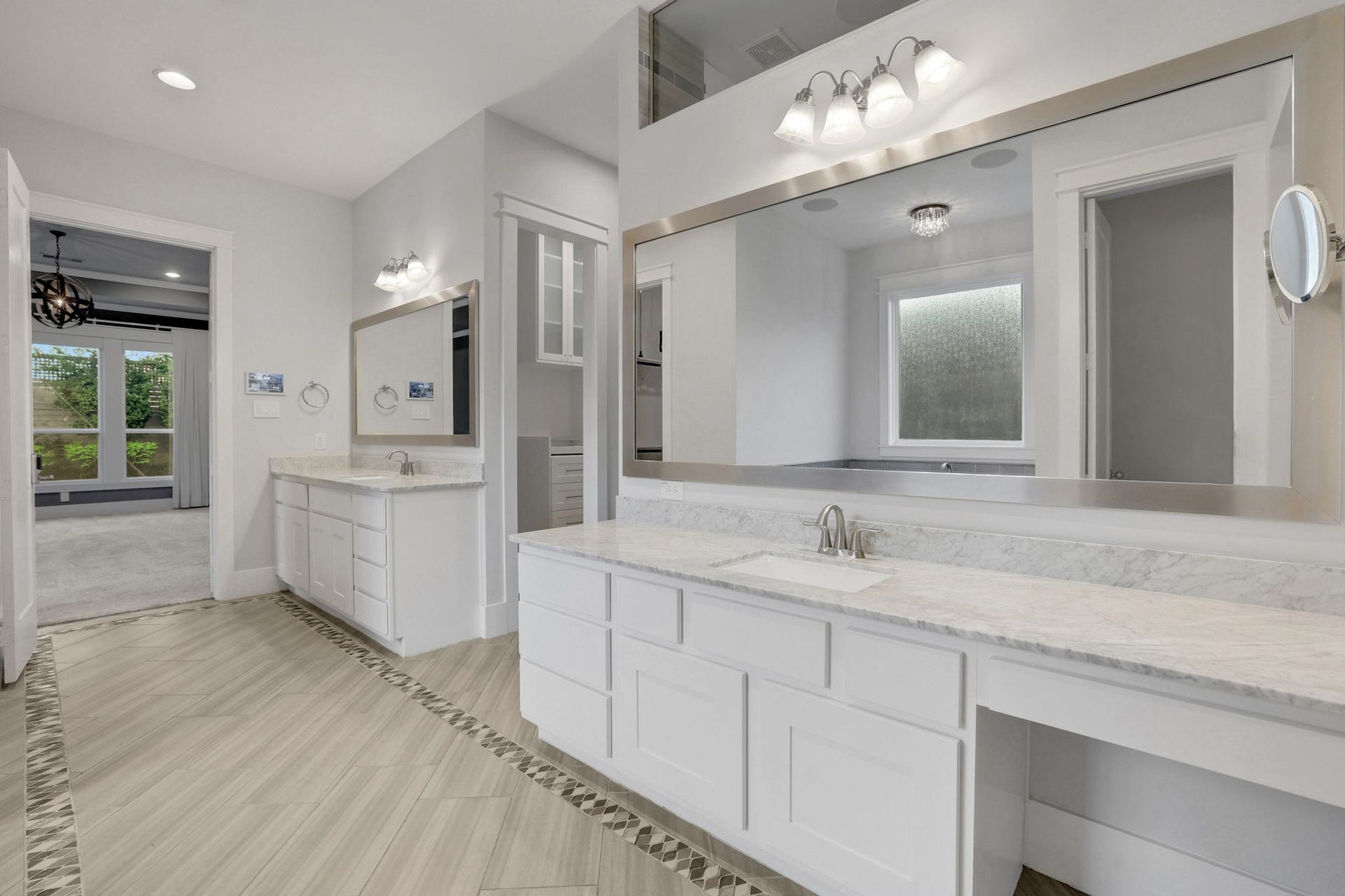 8558 Ridgepoint Drive, Houston, TX 77055 A broad vanity with layered lighting and storage below.
