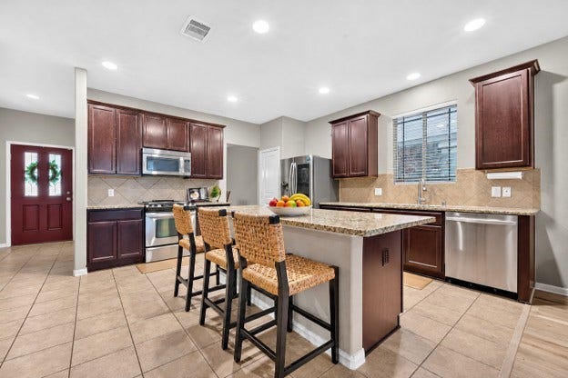 Kitchen: Granite countertops, stainless steel appliances, ample storage, large island giving extra seating
