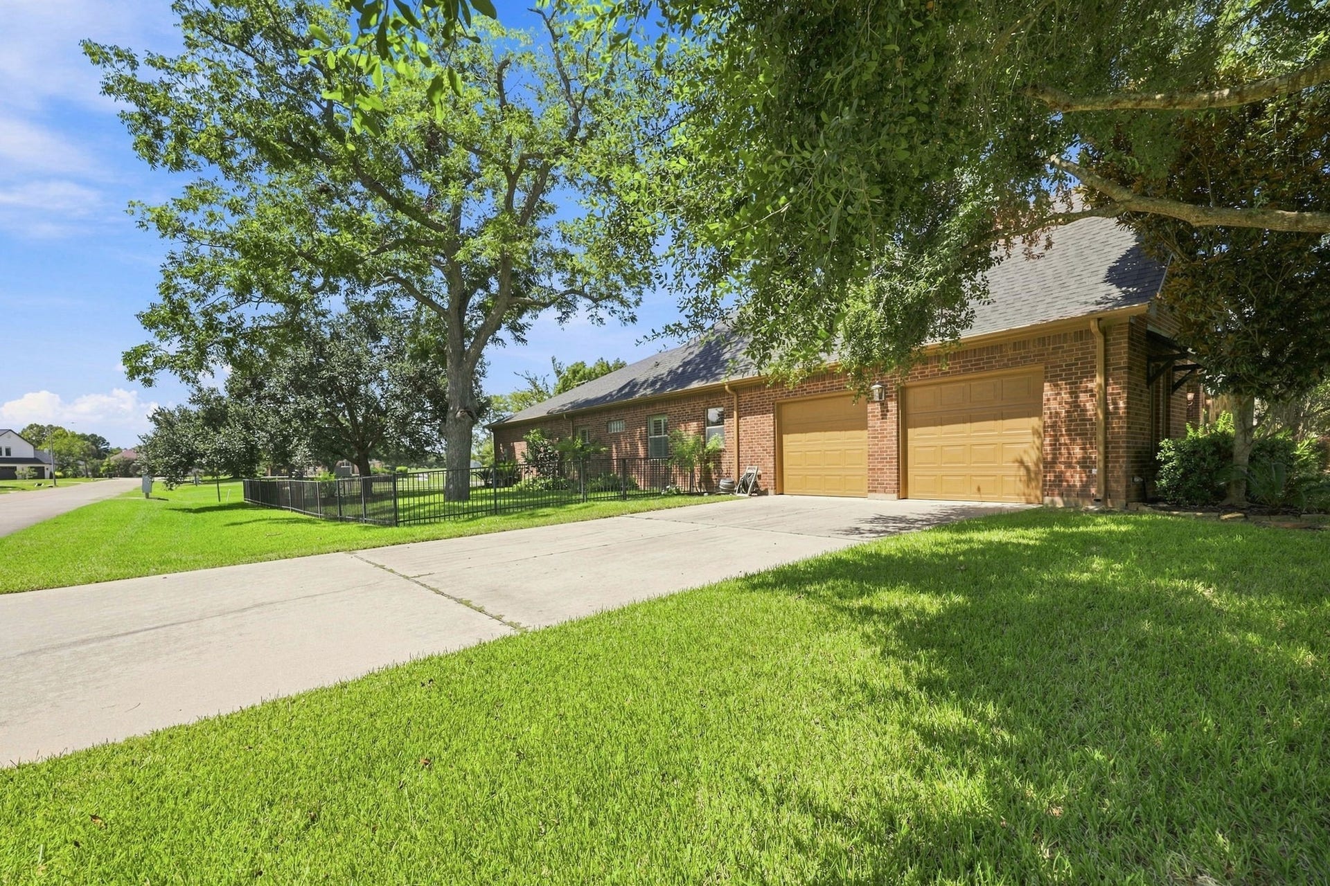 5411 Woodbury Street, Fulshear, TX 77441 The property also features a separate garage entrance along the side of the home, providing additional parking and convenient access for family and guests. The generous driveway and side-entry configuration offer plenty of space for entertaining and everyday living.
