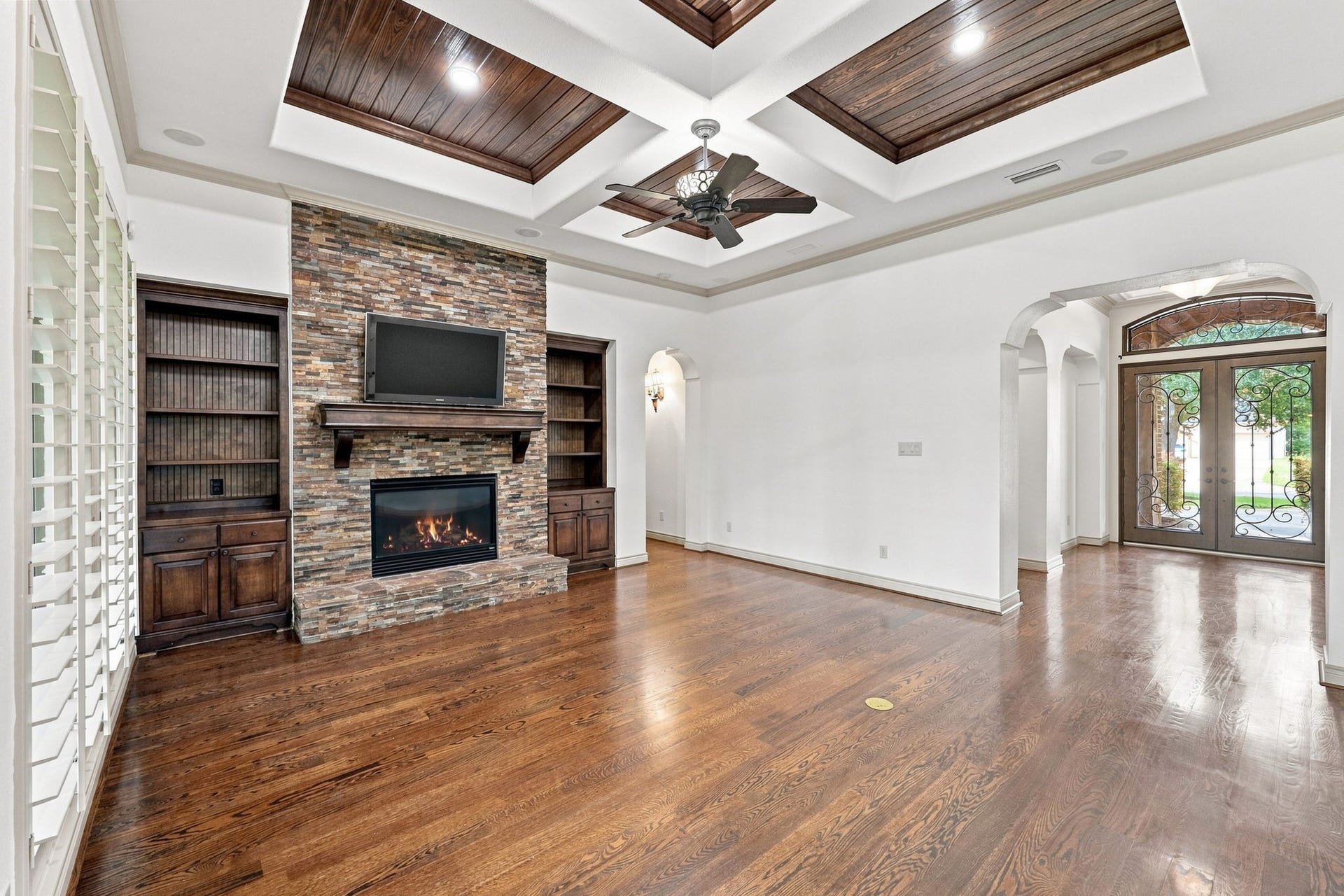 5411 Woodbury Street, Fulshear, TX 77441 This view from the opposite side of the Family Room looks back toward the Foyer, offering a better perspective of the rooms impressive scale, architectural details, and seamless connection to the entryway. The open, thoughtfully designed layout creates an inviting flow throughout the main living spaces.