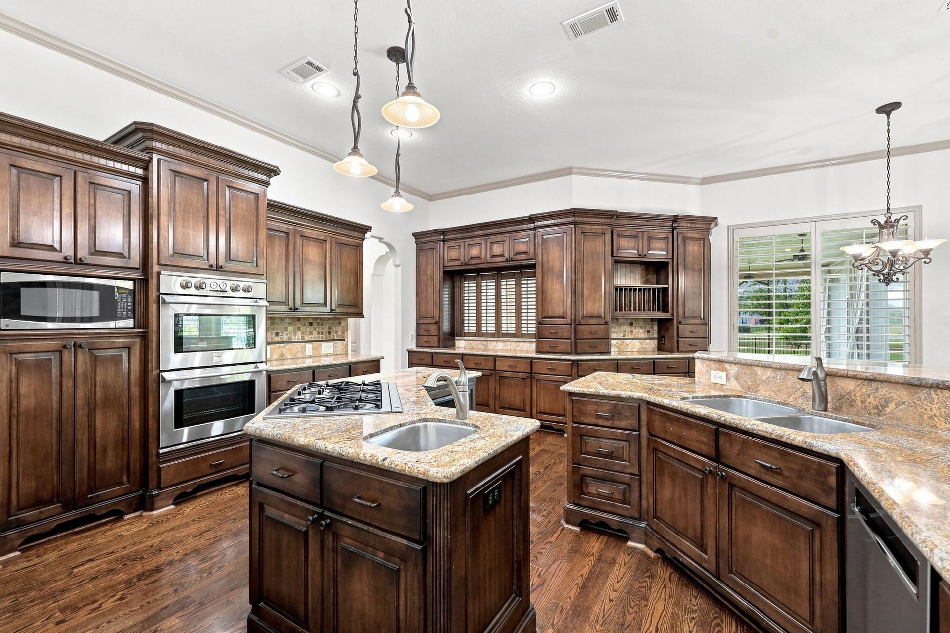 5411 Woodbury Street, Fulshear, TX 77441 The Kitchen is equipped with a premium stainless steel appliance package, including Kenmore Pro double convection ovens, Refrigerator, a five-burner gas cooktop, and a KitchenAid dishwasher. This impressive combination provides the performance and versatility needed for everything from everyday meals to elaborate entertaining. Please note, the refrigerator icemaker does not work.