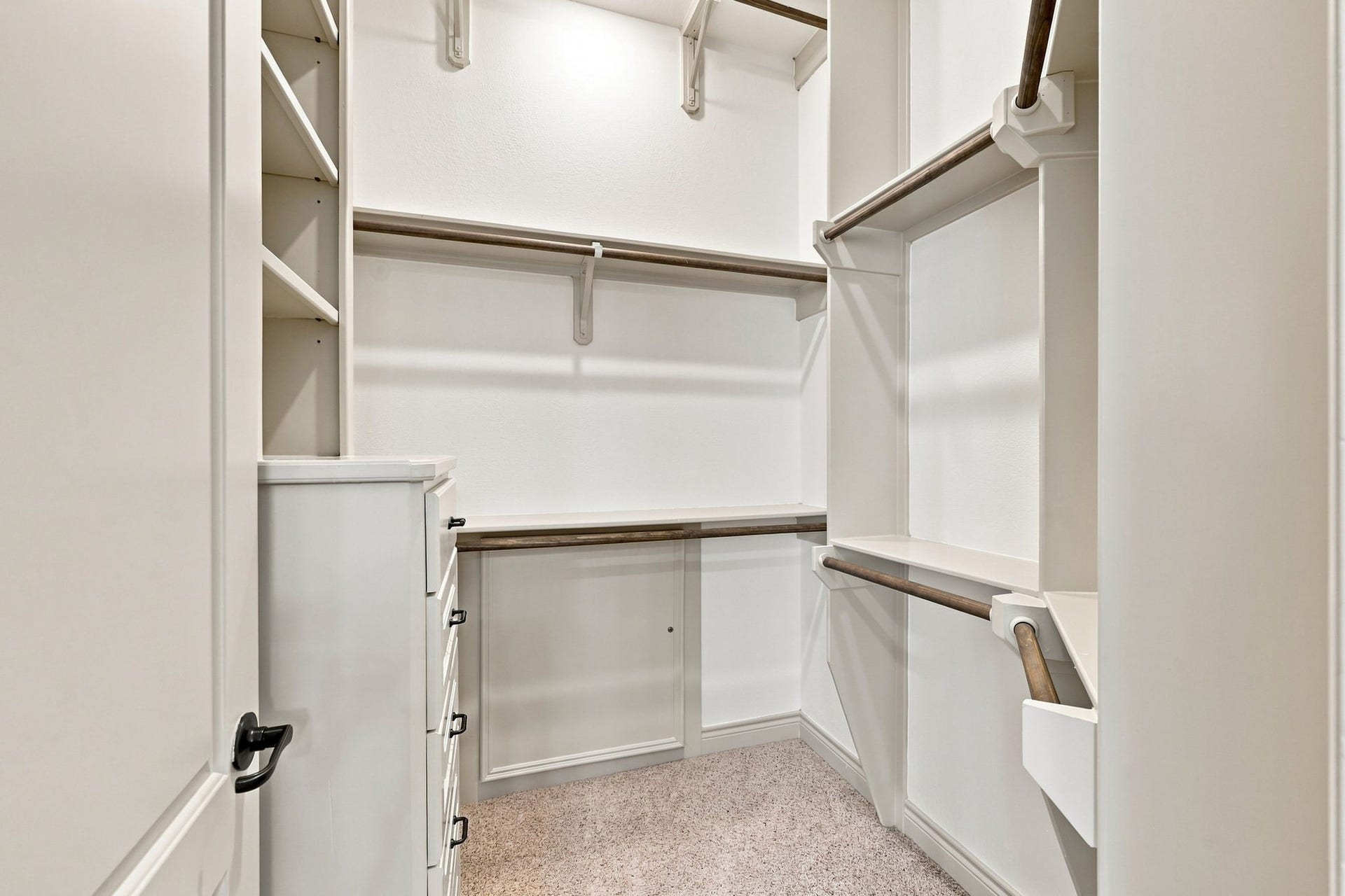 5411 Woodbury Street, Fulshear, TX 77441 The second closet offers additional storage and organization, featuring a built-in chest of drawers for convenient storage of clothing and personal items. The thoughtful built-in design maximizes functionality while maintaining a clean, polished appearance.