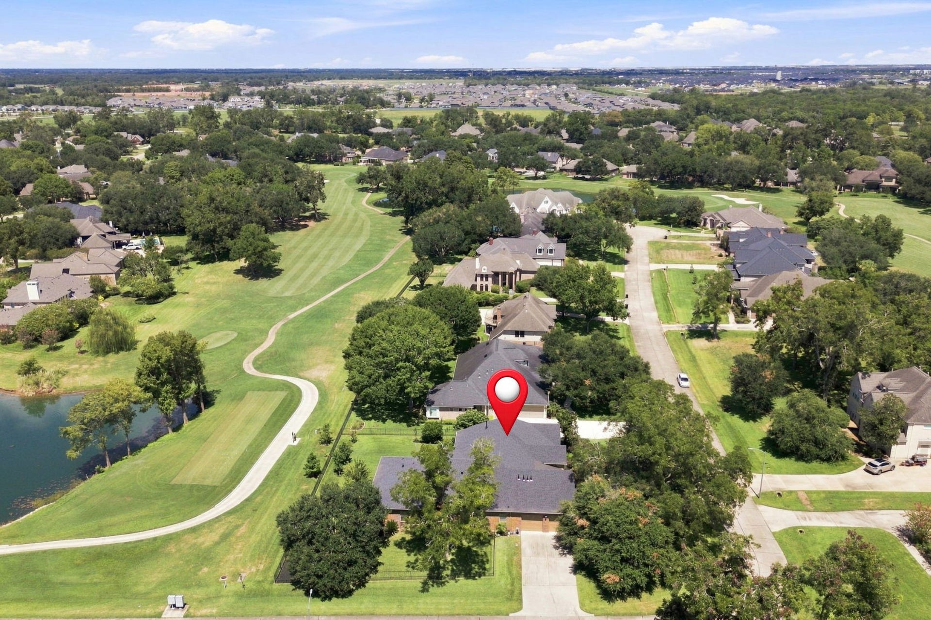 5411 Woodbury Street, Fulshear, TX 77441 This beautiful view looks north down the 2nd fairway, showcasing the picturesque golf course setting and the expansive views enjoyed from the property.