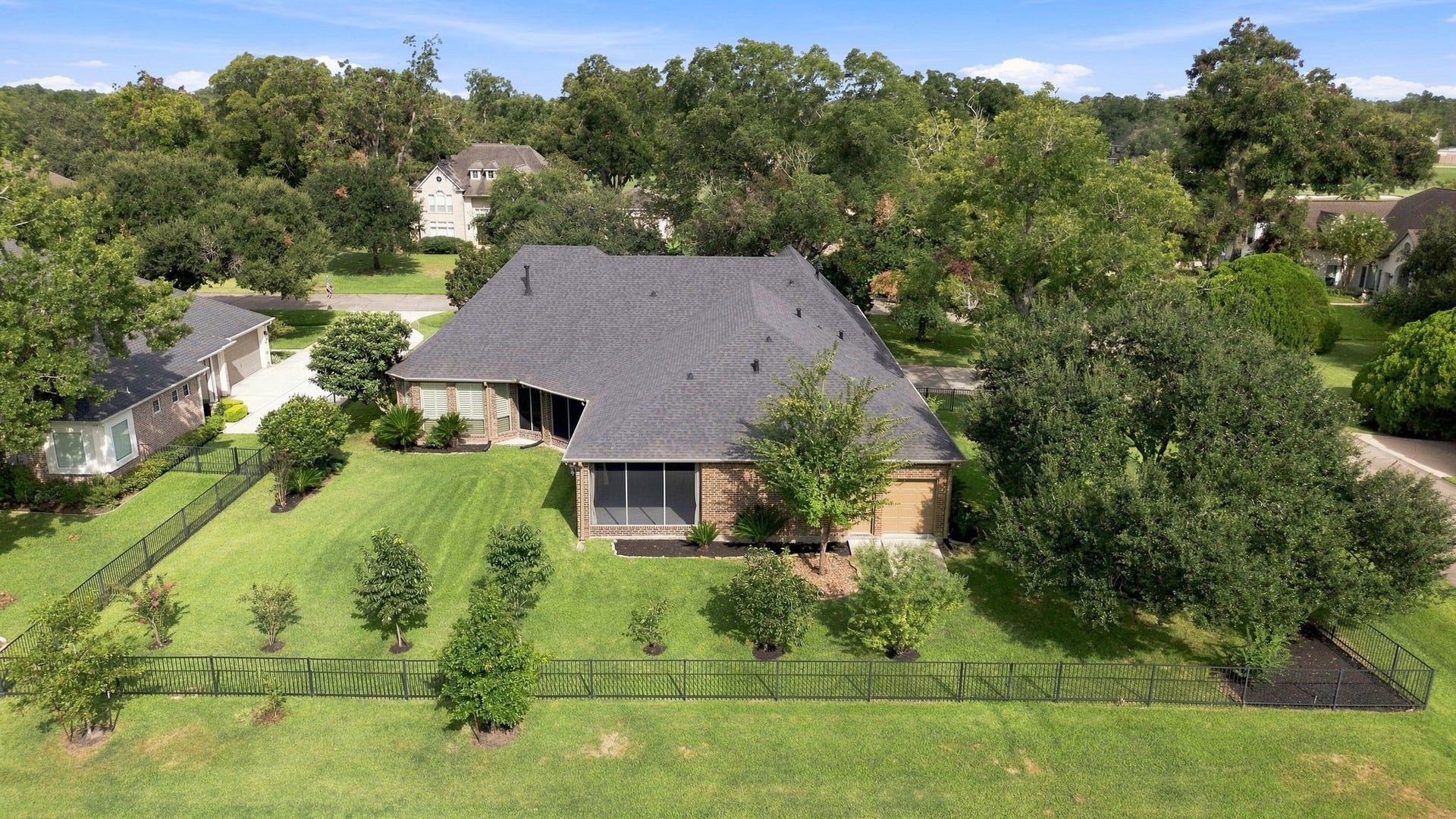 5411 Woodbury Street, Fulshear, TX 77441 A closer look at the spacious backyard showcases the generous outdoor space, mature landscaping, and peaceful golf course setting beyond. With plenty of room for a pool and additional outdoor living, this backyard offers endless possibilities for creating your own private retreat.