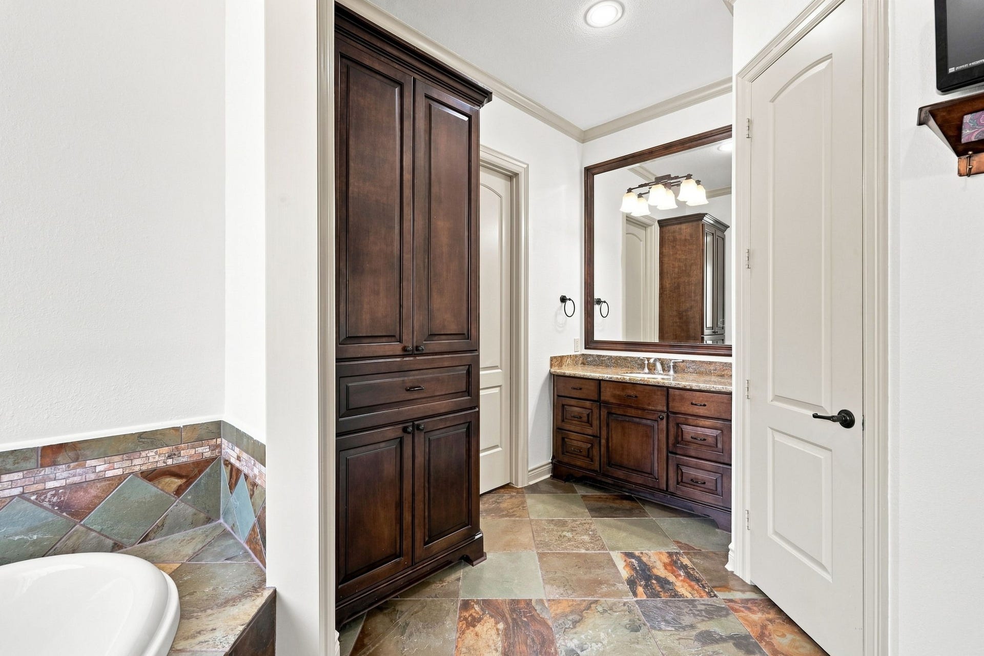 5411 Woodbury Street, Fulshear, TX 77441 This second vanity area features beautiful custom cabinetry and abundant additional storage, providing both elegance and functionality.