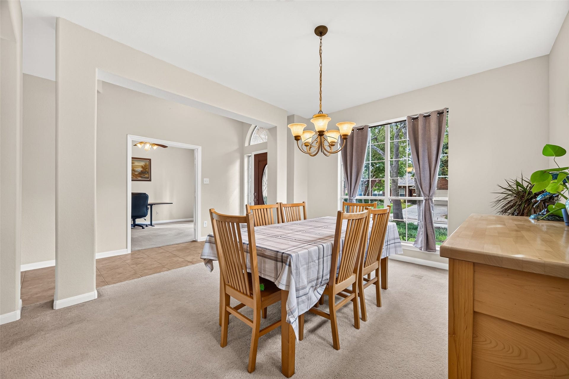 Another view of the formal dining room showcasing its generous size and convenient location near the front entry and private home office.